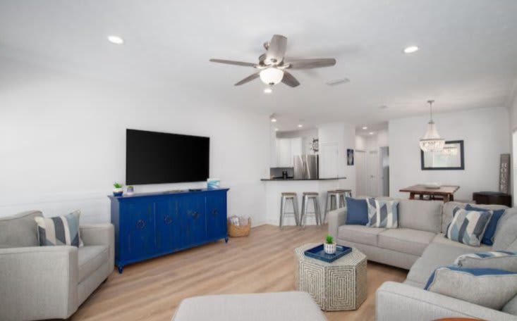 Large family room with 65" smart TV and plenty of seating.