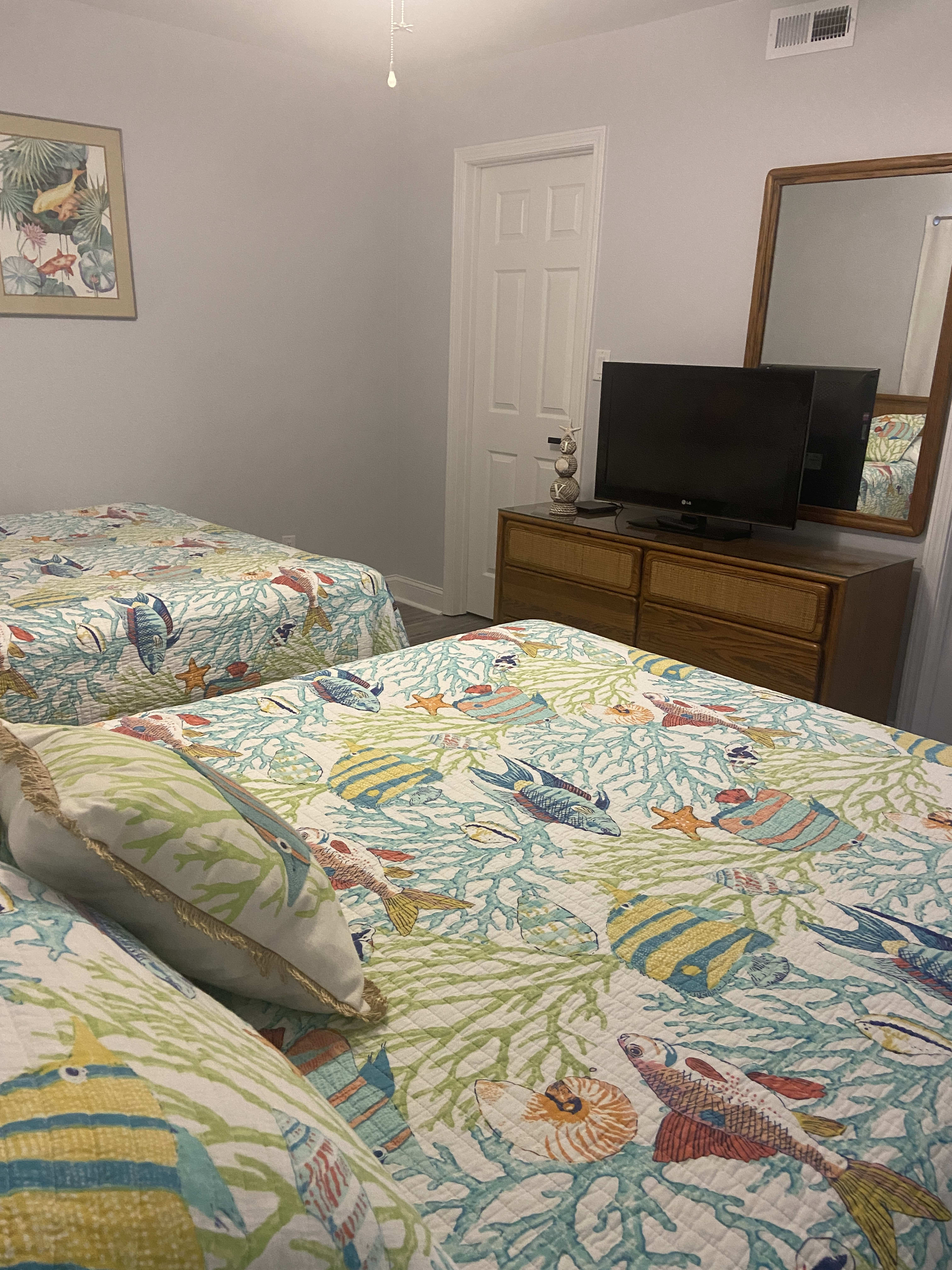 The front bedroom includes a tv and a walk-in closet. 