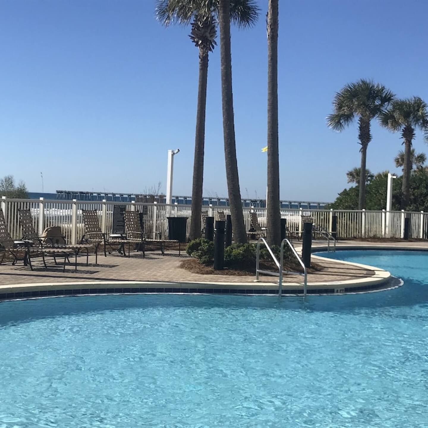 Large gulfside pool and second heated pool streetside. Hot tubs on both sides