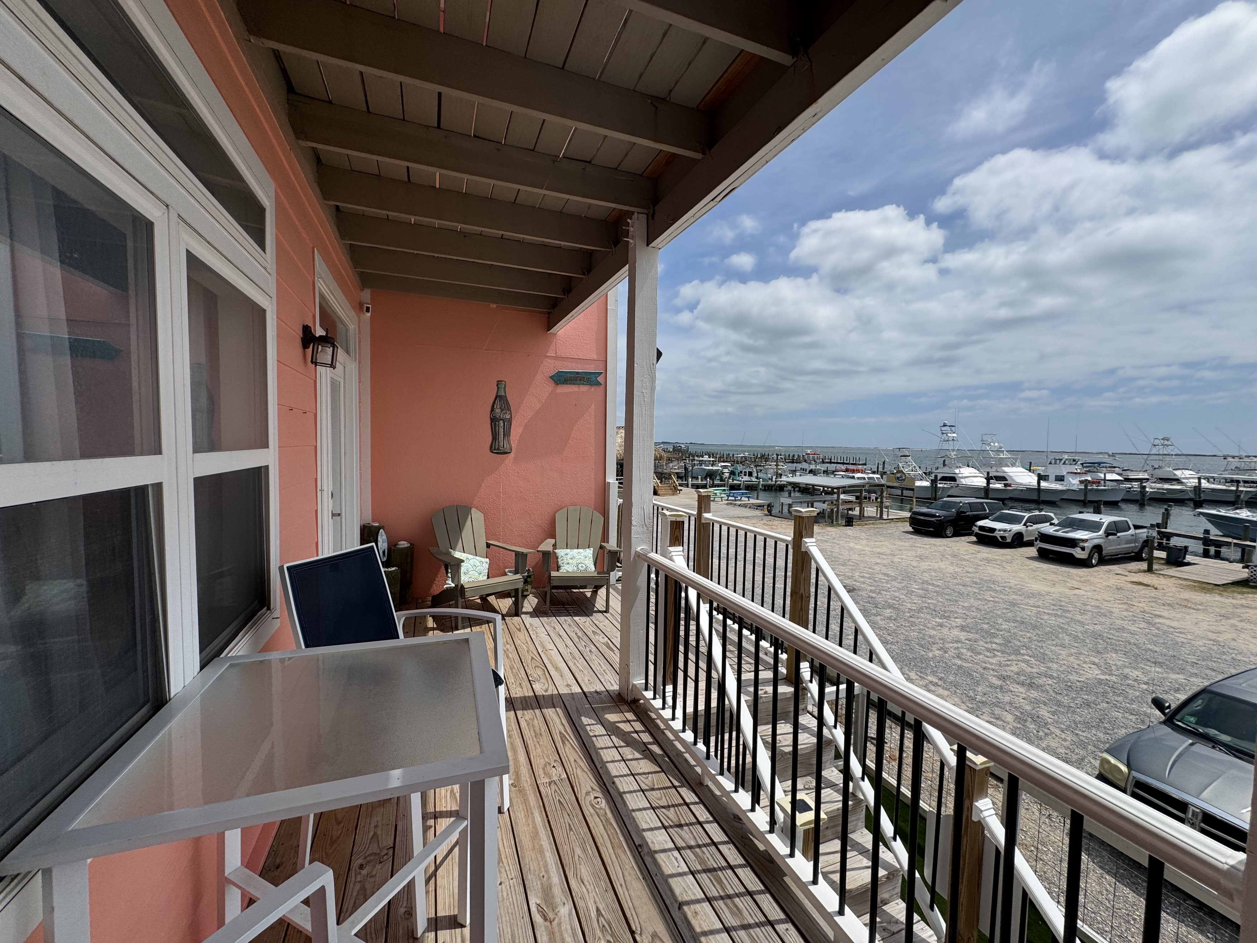 Balcony with patio furniture overlooking the water and marina