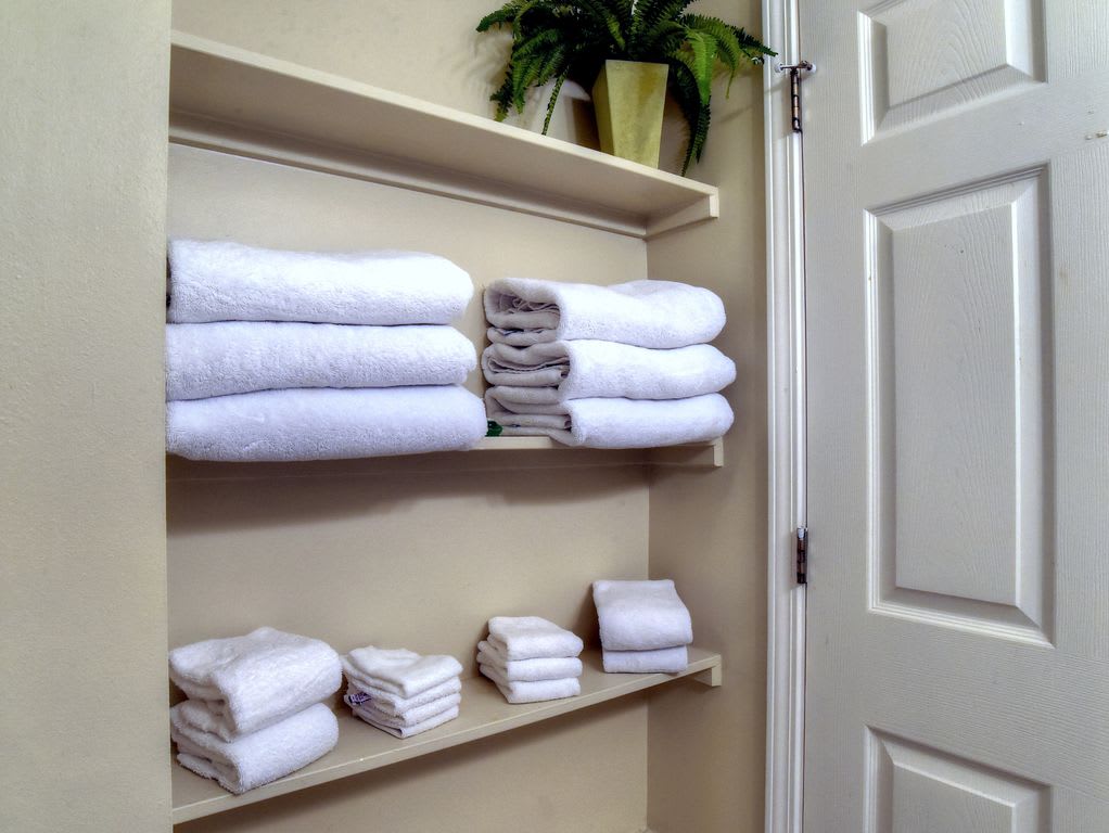 Shelf where additional linens are stored