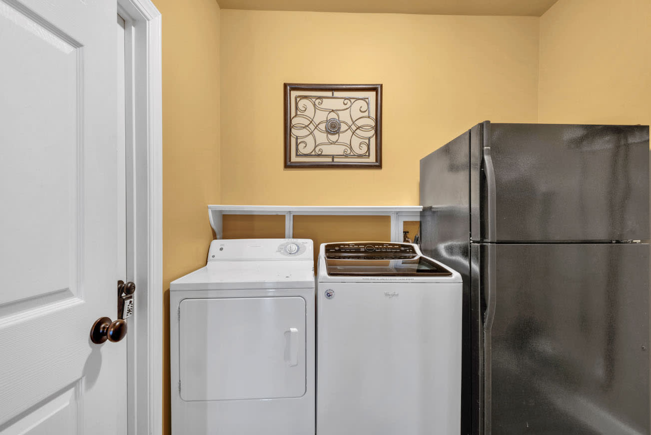 Laundry room with 2nd refrigerator.  