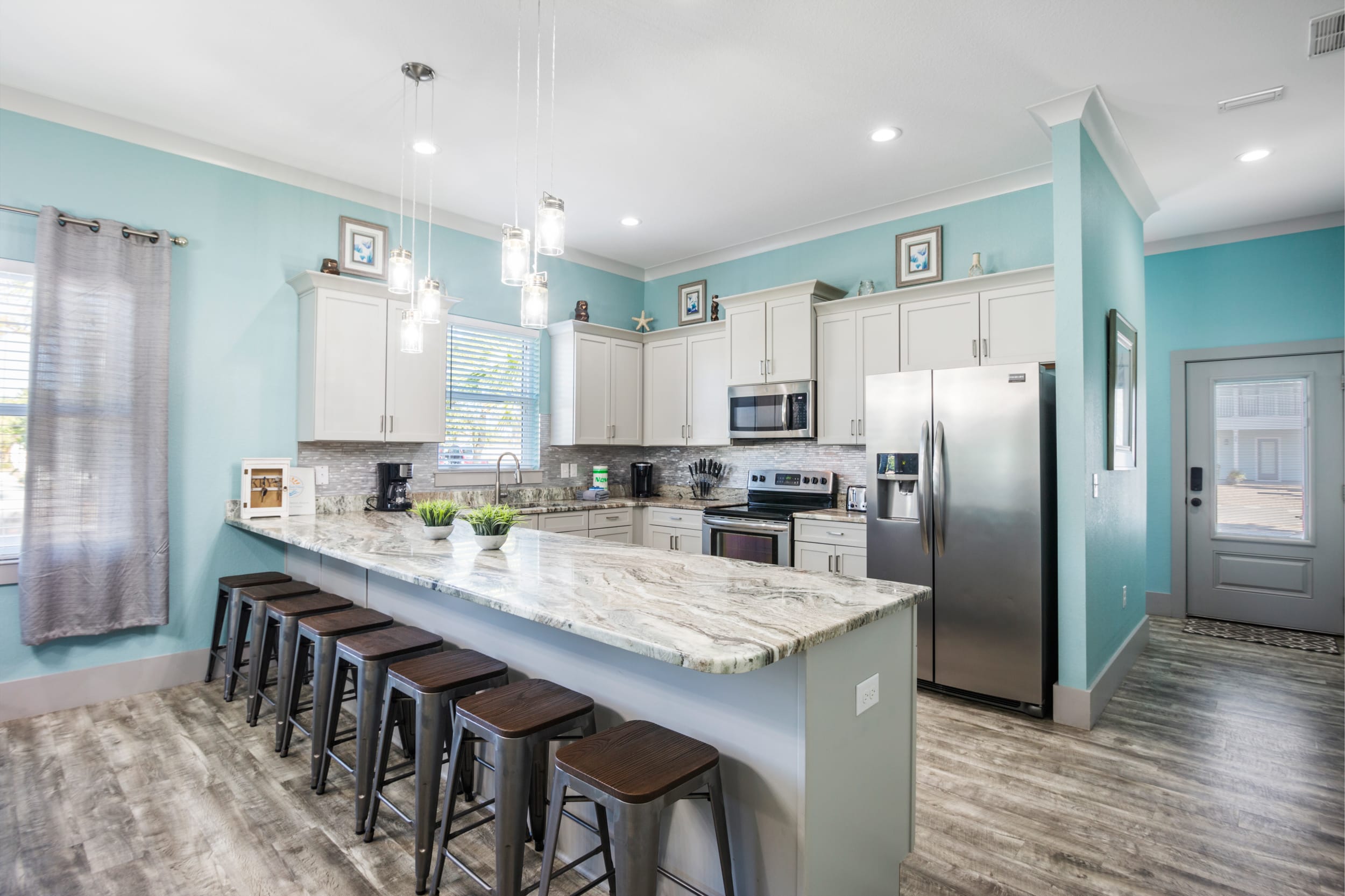 Large, spacious kitchen has luxury granite countertops, plenty of bar seating