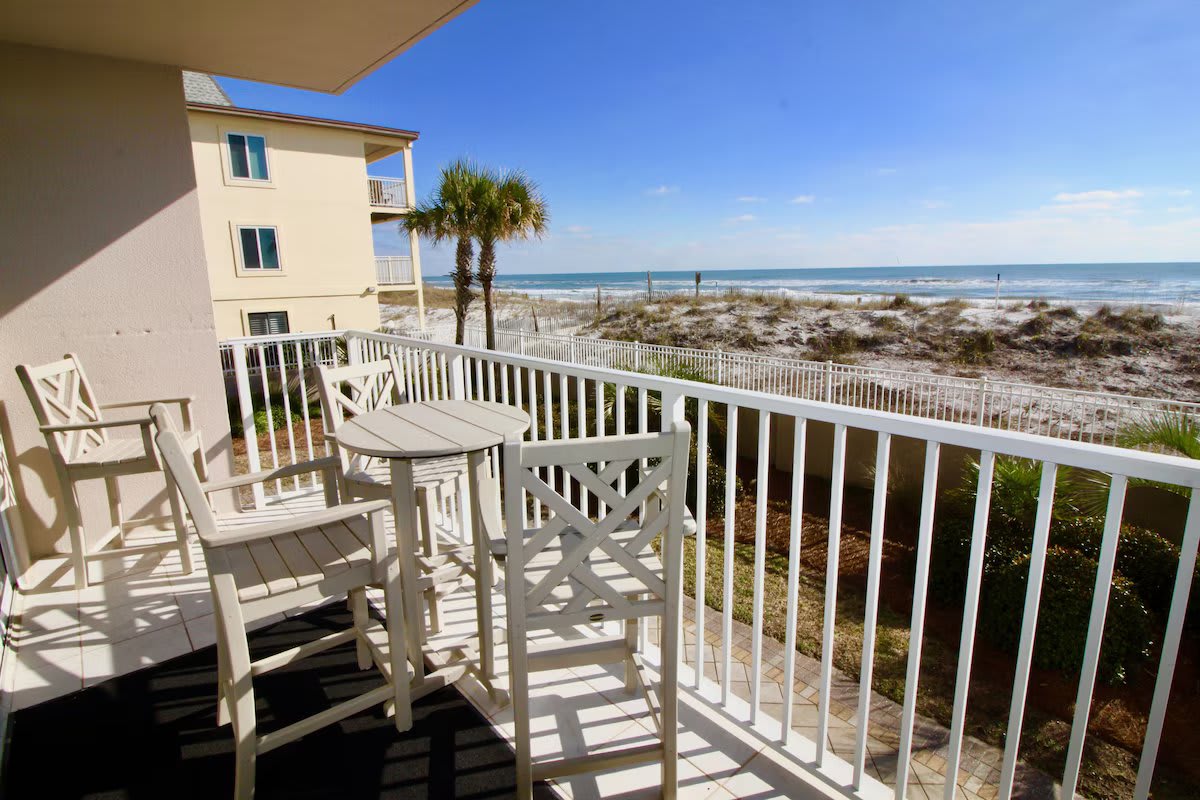Balcony view. Four pub height chairs and a table