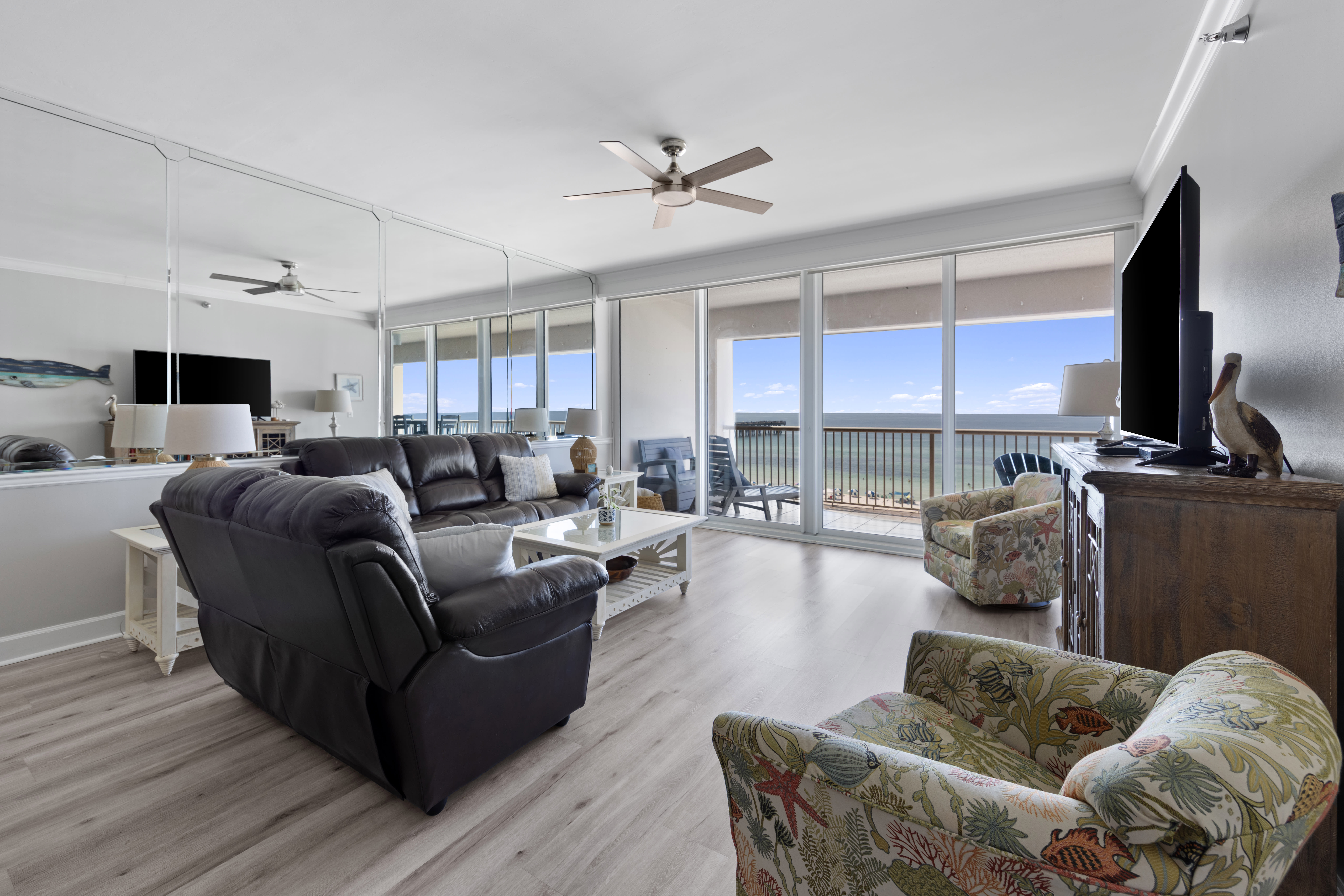 Living Room with Private Balcony Access and 60 Inch Smart TV
