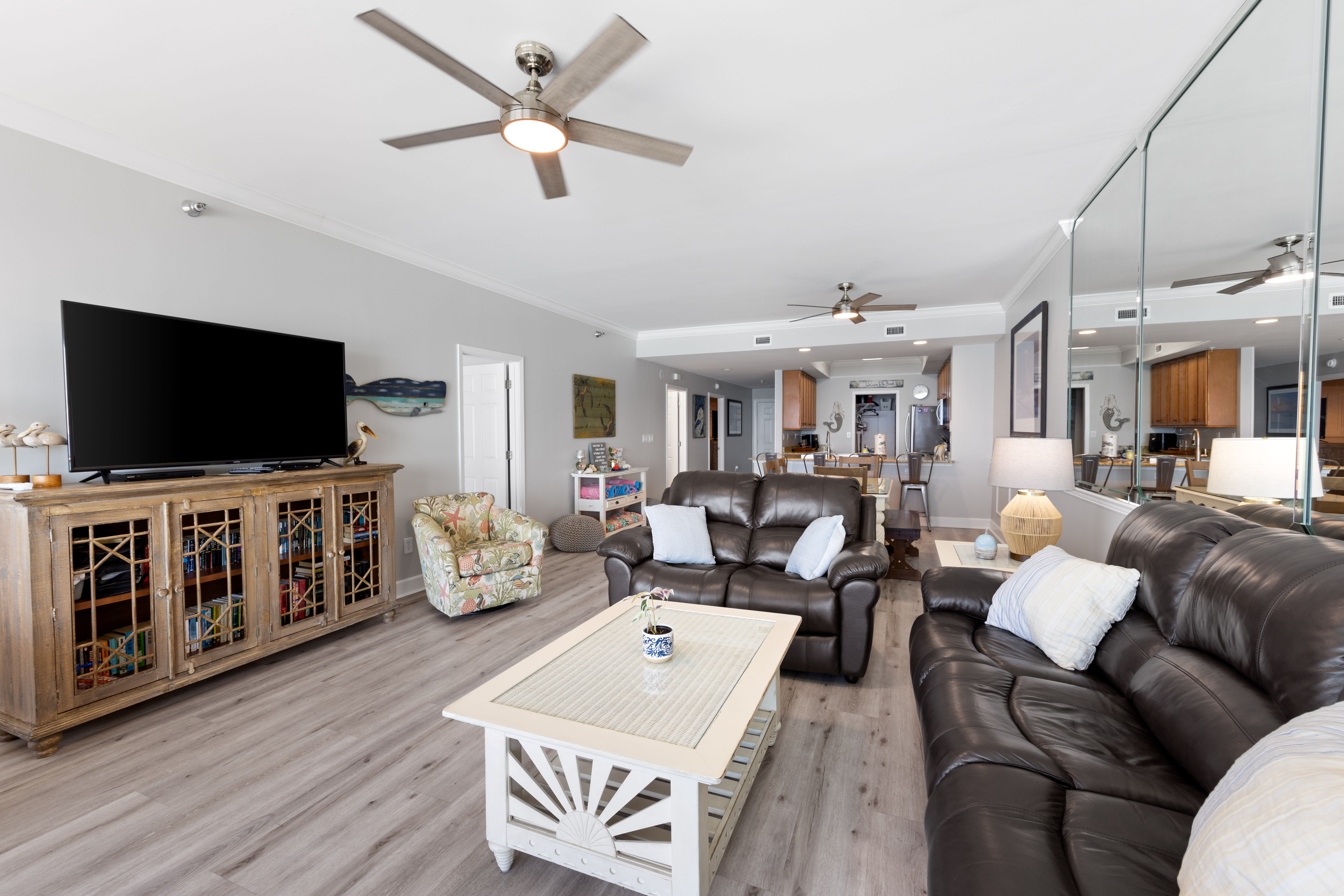 Living Room with Private Balcony Access and 60 Inch Smart TV