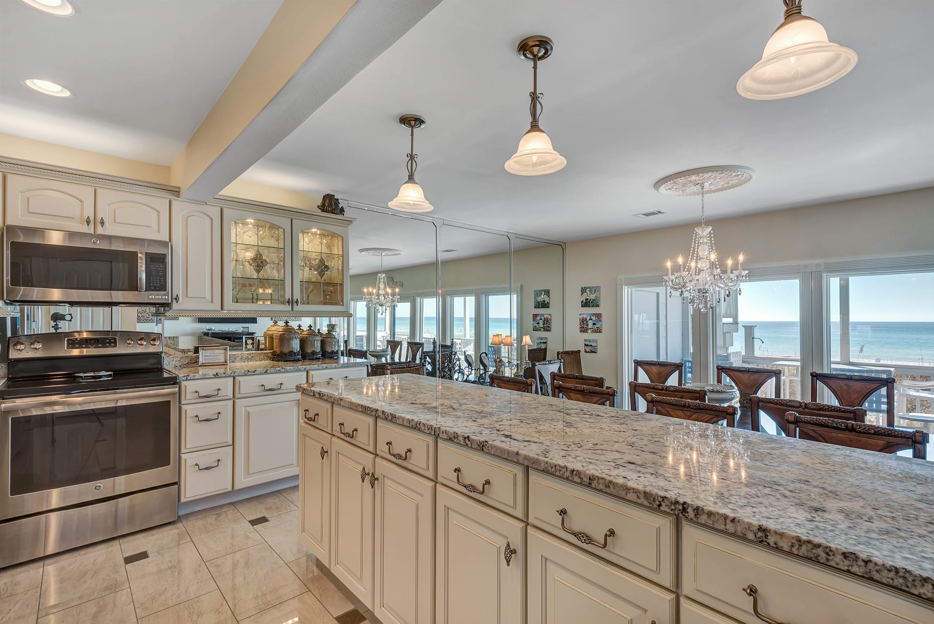 Kitchen and Dining Room with Ocean Viewed out of Floor-to-Ceiling Windows 