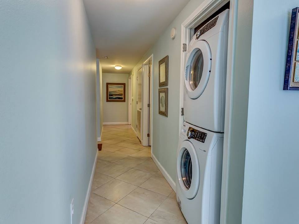 Hallway to bedrooms. Nice full size front end load washer/dryer. 