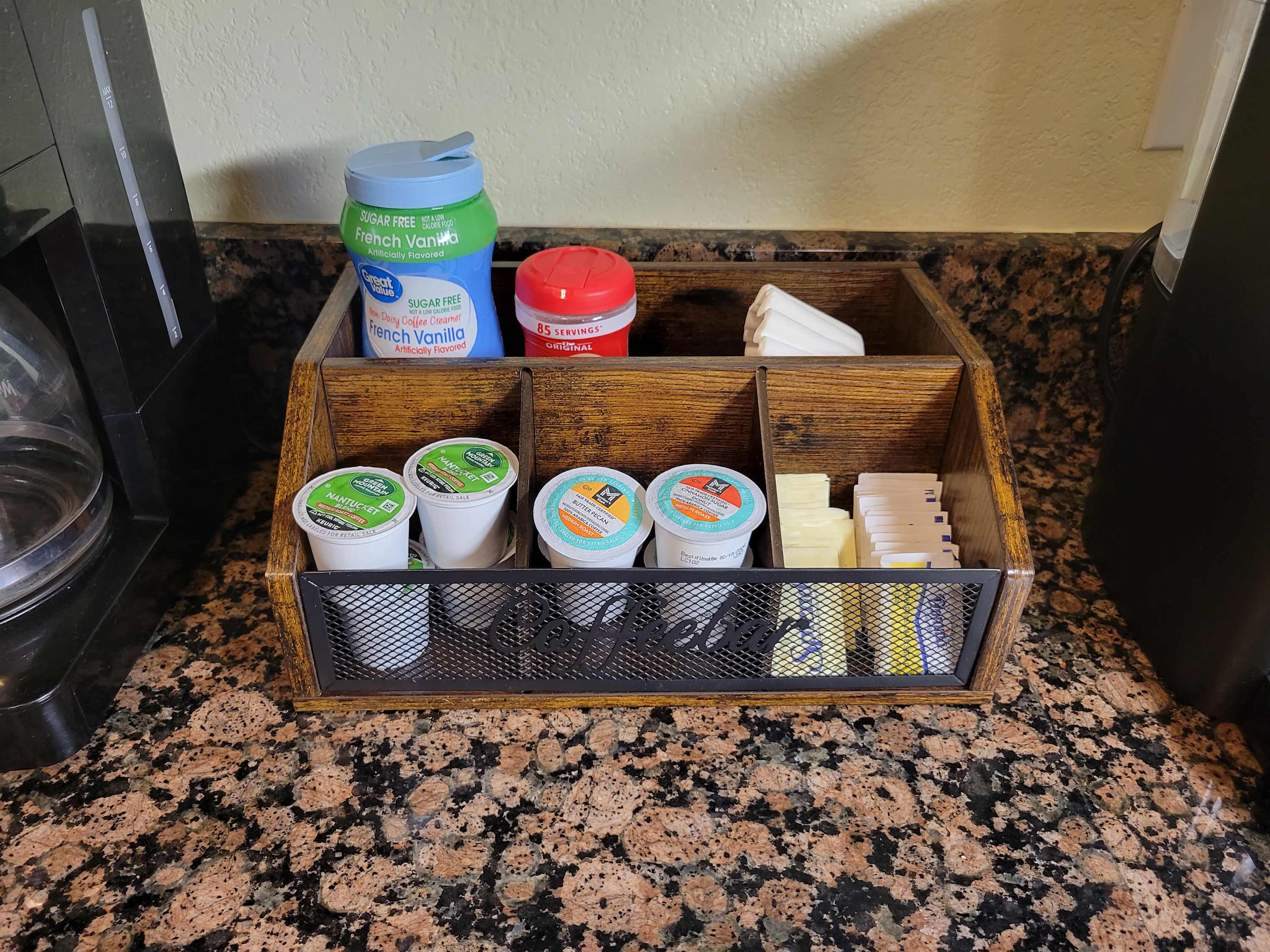 Coffee bar with assorted K-cups, sugar, sweetener, filters and creamer.