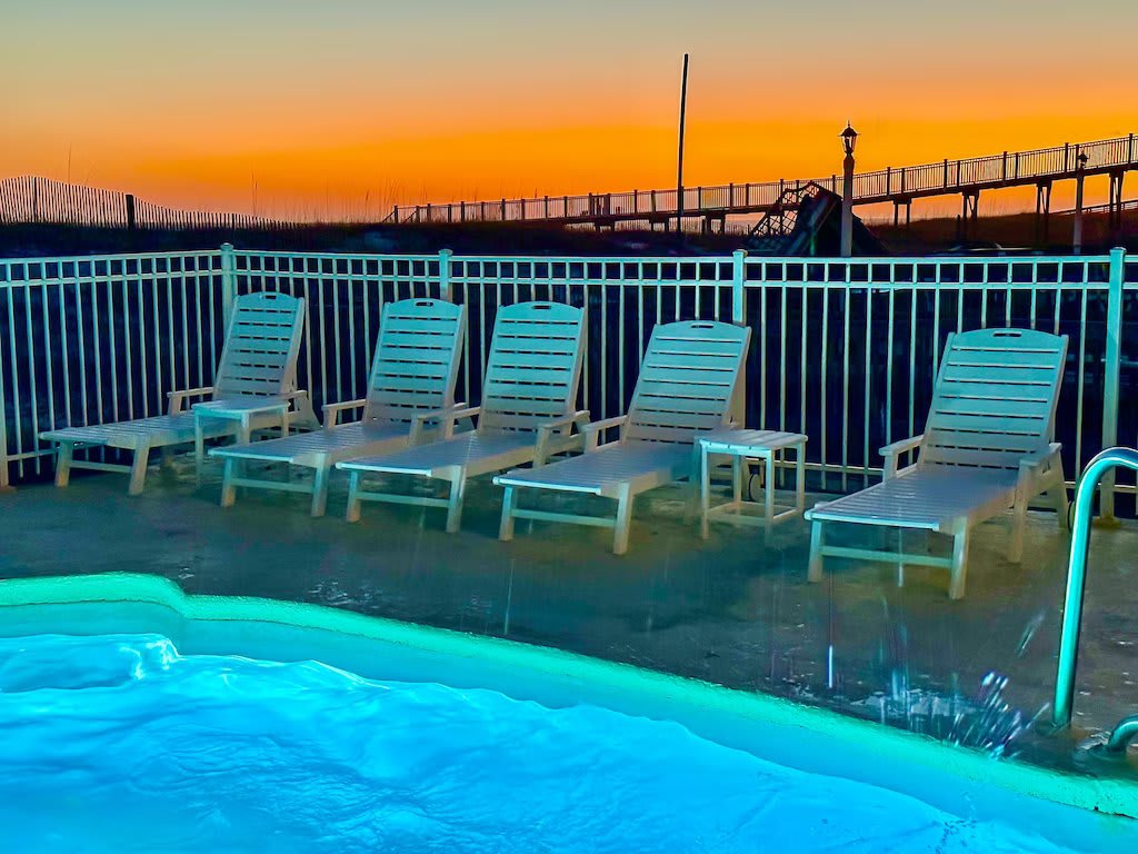 Enjoy the heated lit beachside pool under a soft glowing twilight sky!