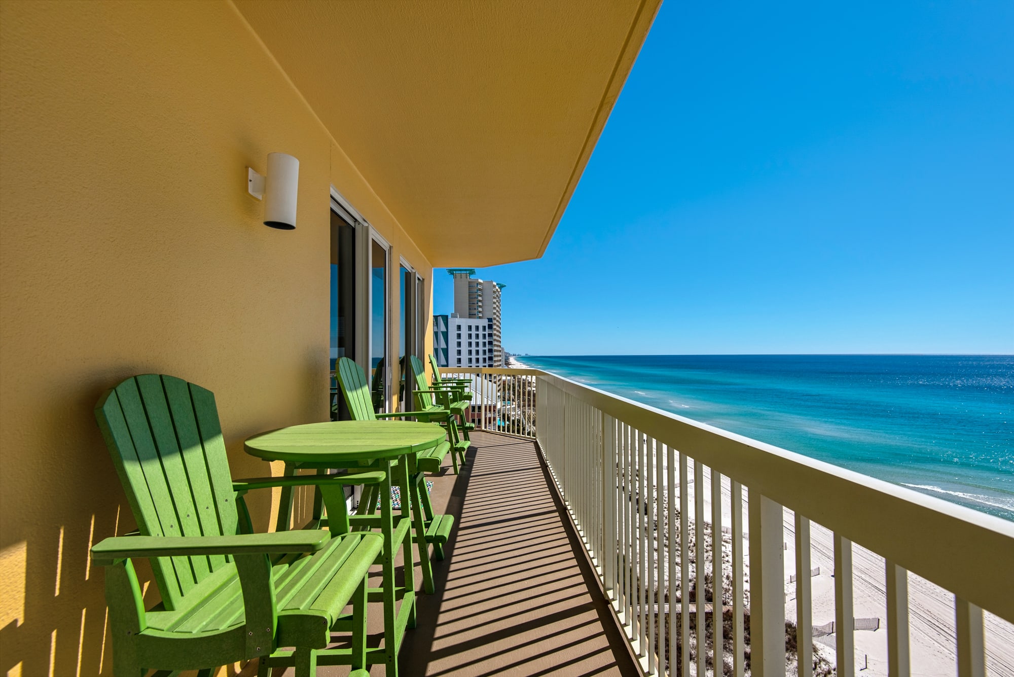 Large Beach Front private balcony with 6 chairs and a table.