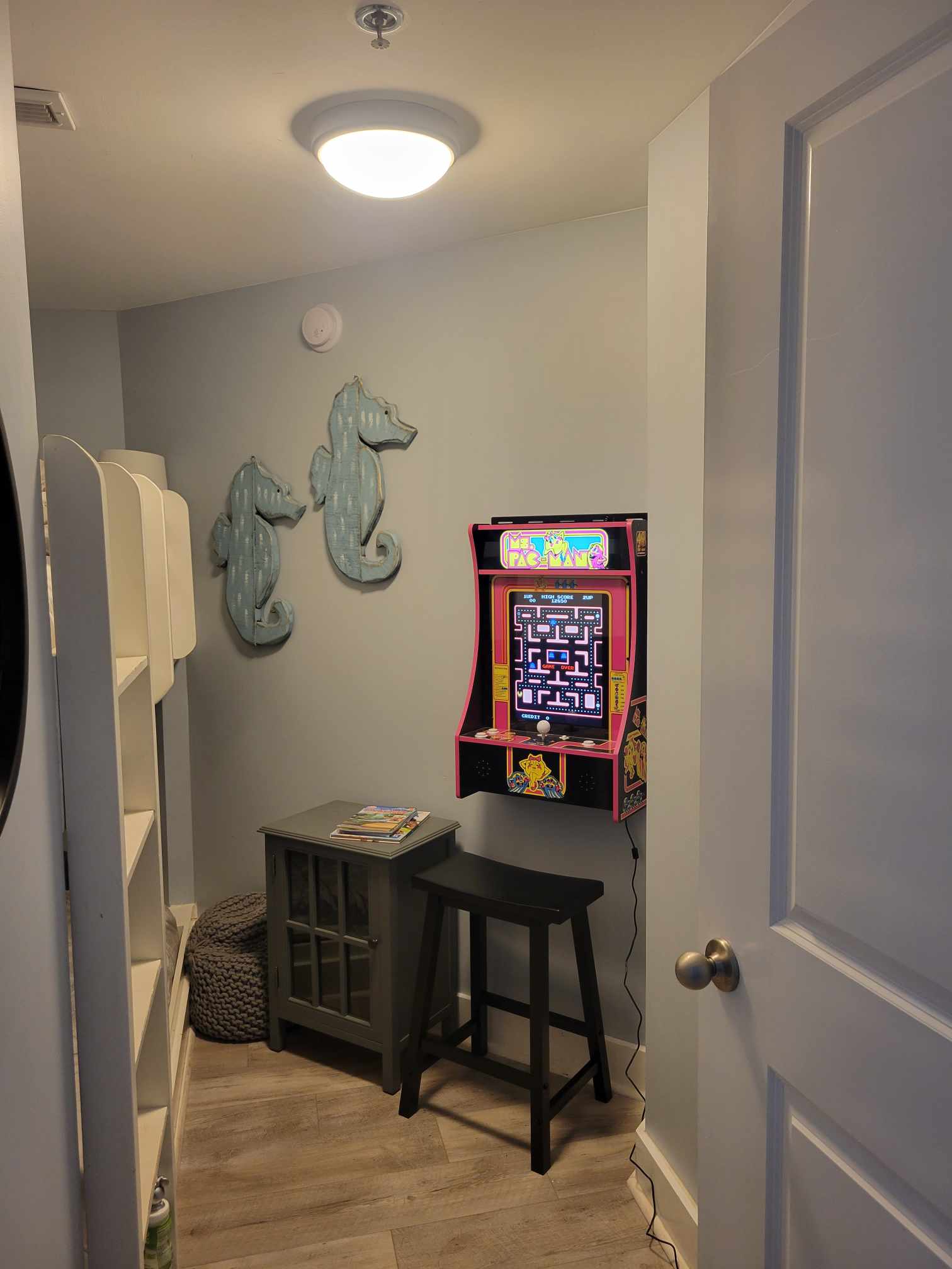 Enclosed bunk room with only arcade game at Waterscape!