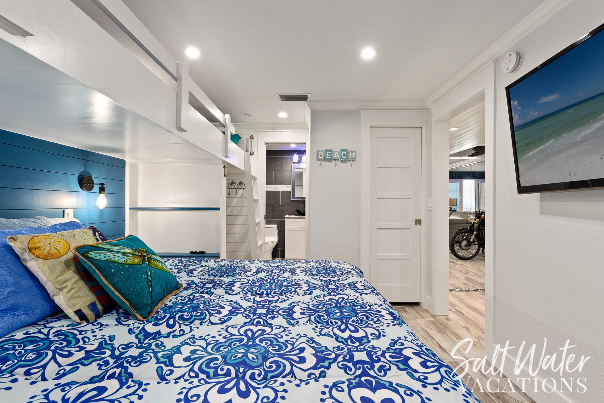 King bunk room with view of private  bathroom entrance 