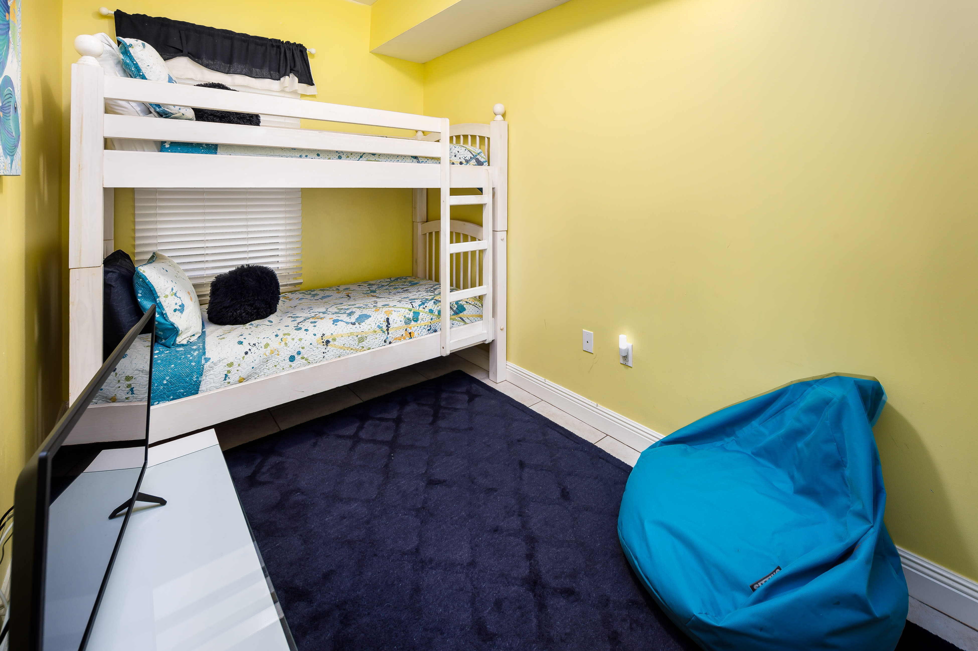 Bunk beds, TV, and comfy seating in the kids' room!