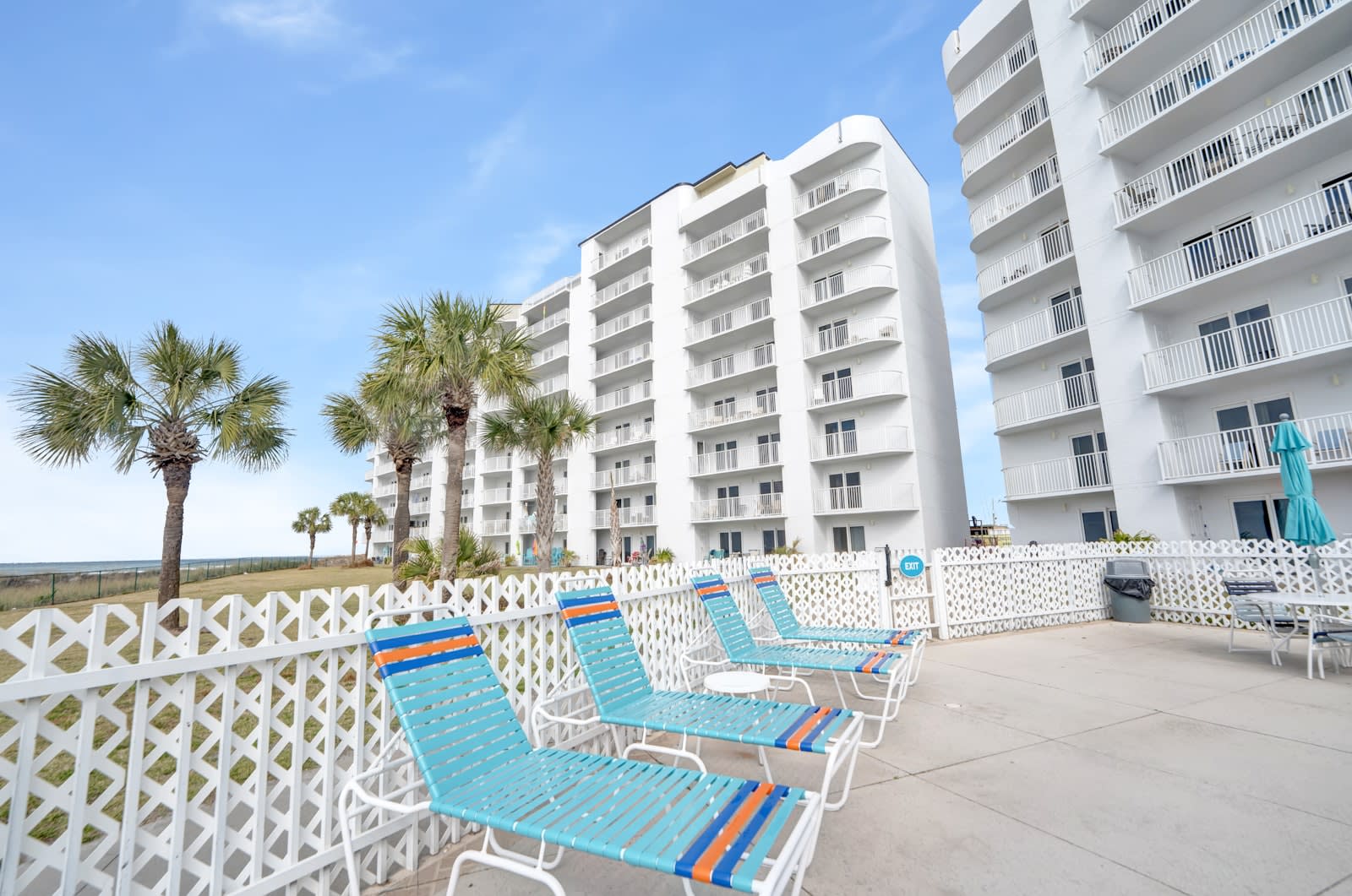 Exterior view from pool area. Tables and loungers available for use.
