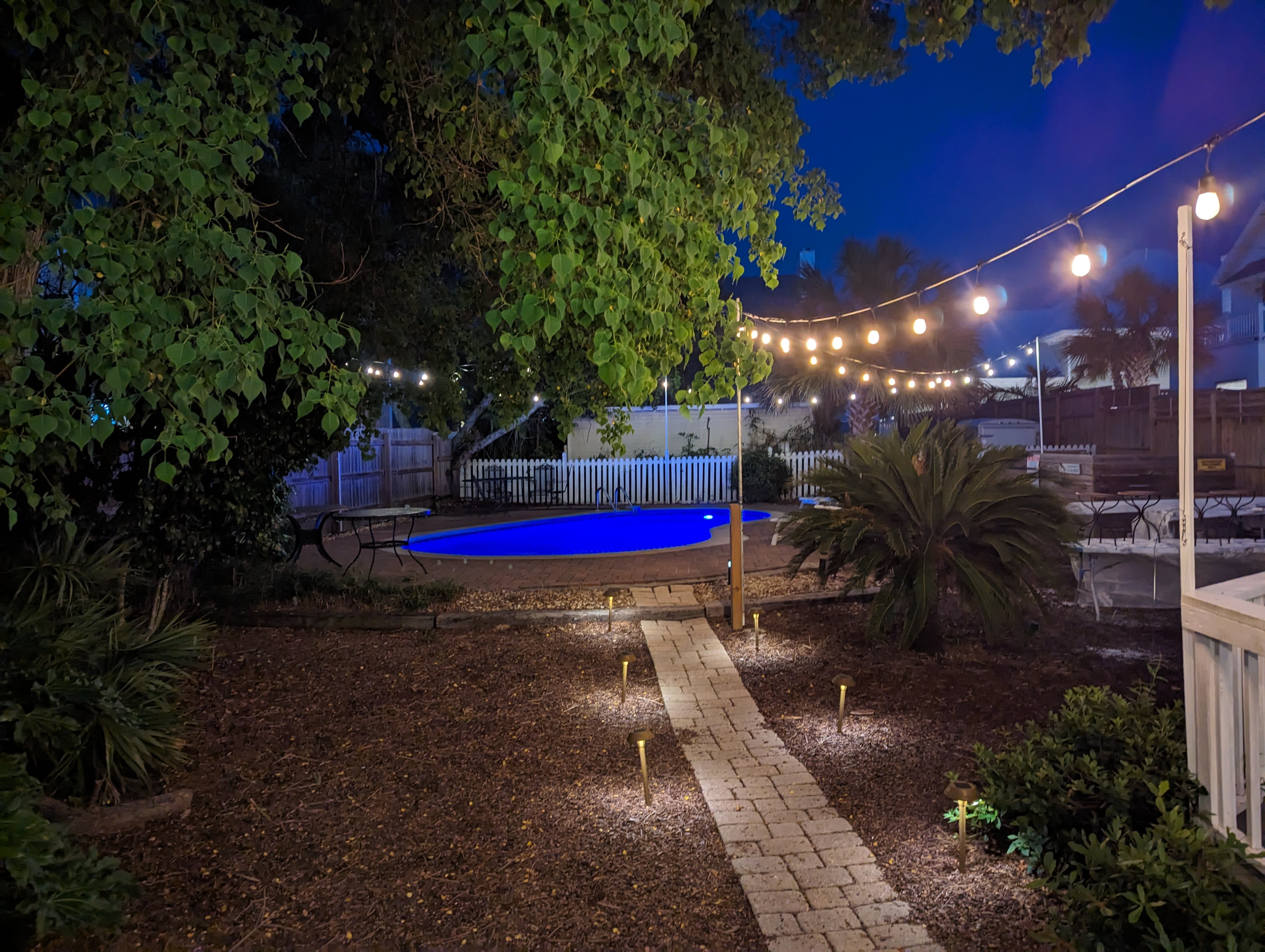 The LED and pool lights bring this backyard to life.