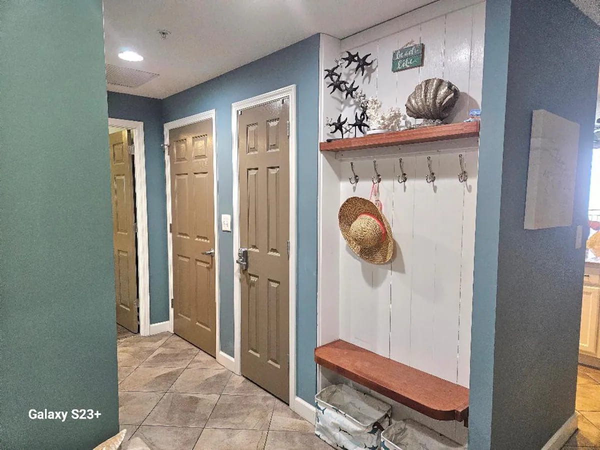 Entry hall with coat hooks for jackets or towels. Totes below for those sandy shoes.