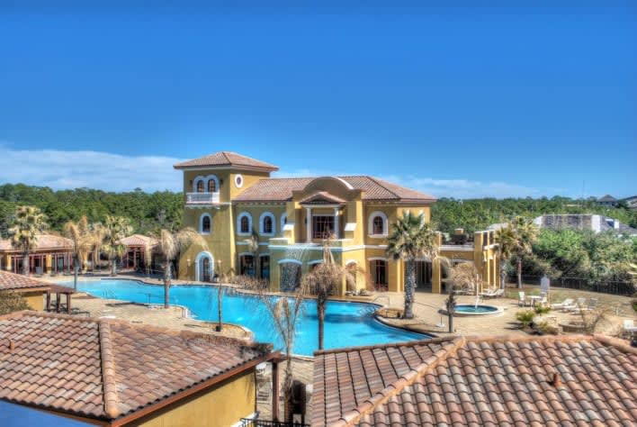View of huge swimming pool club house from the front door of the condo