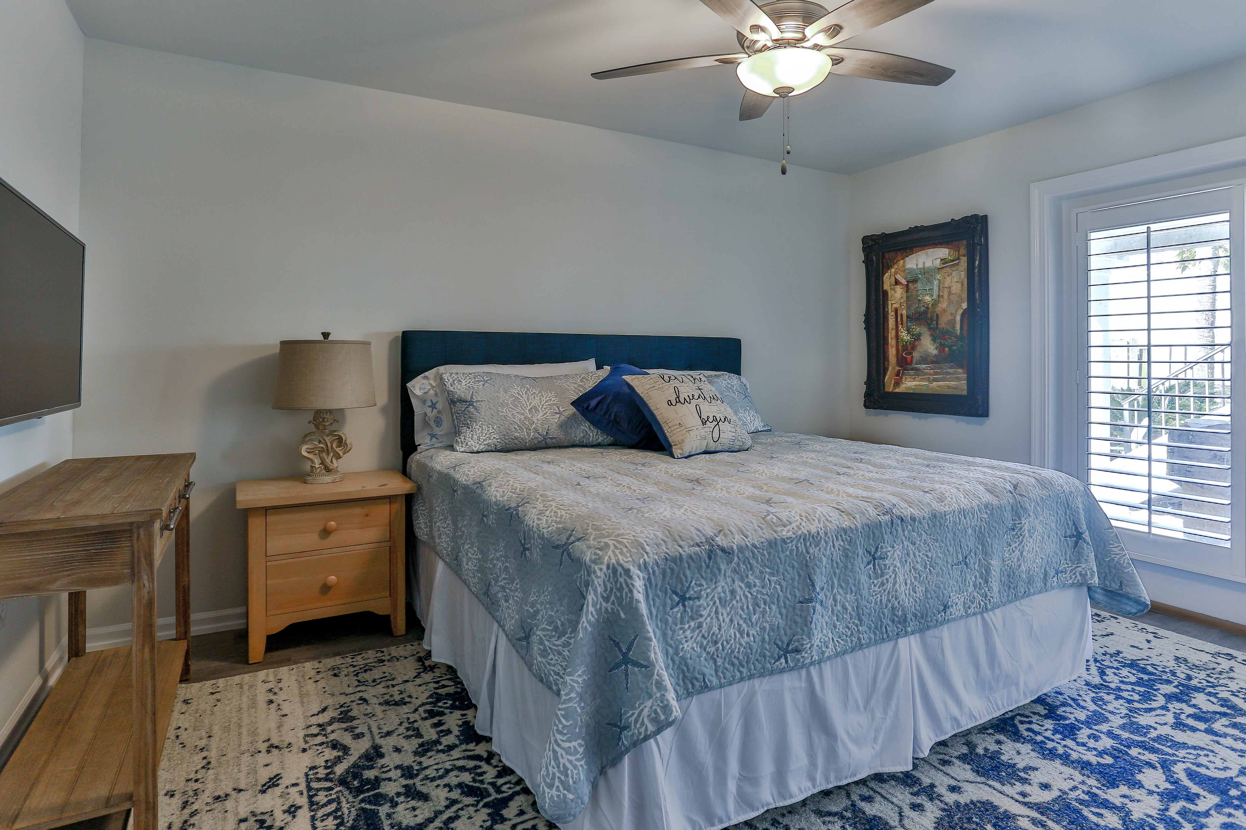 First floor en suite bedroom with door to pool and outdoor kitchen areas