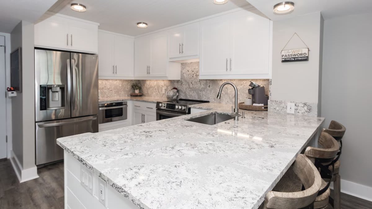 Updated and fully-stocked kitchen with quartz counters &amp; stainless appliances.