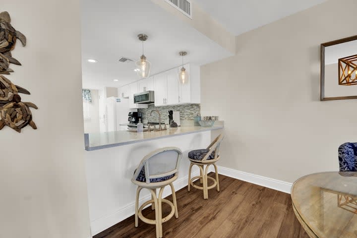 Counter seating next to dining table. 