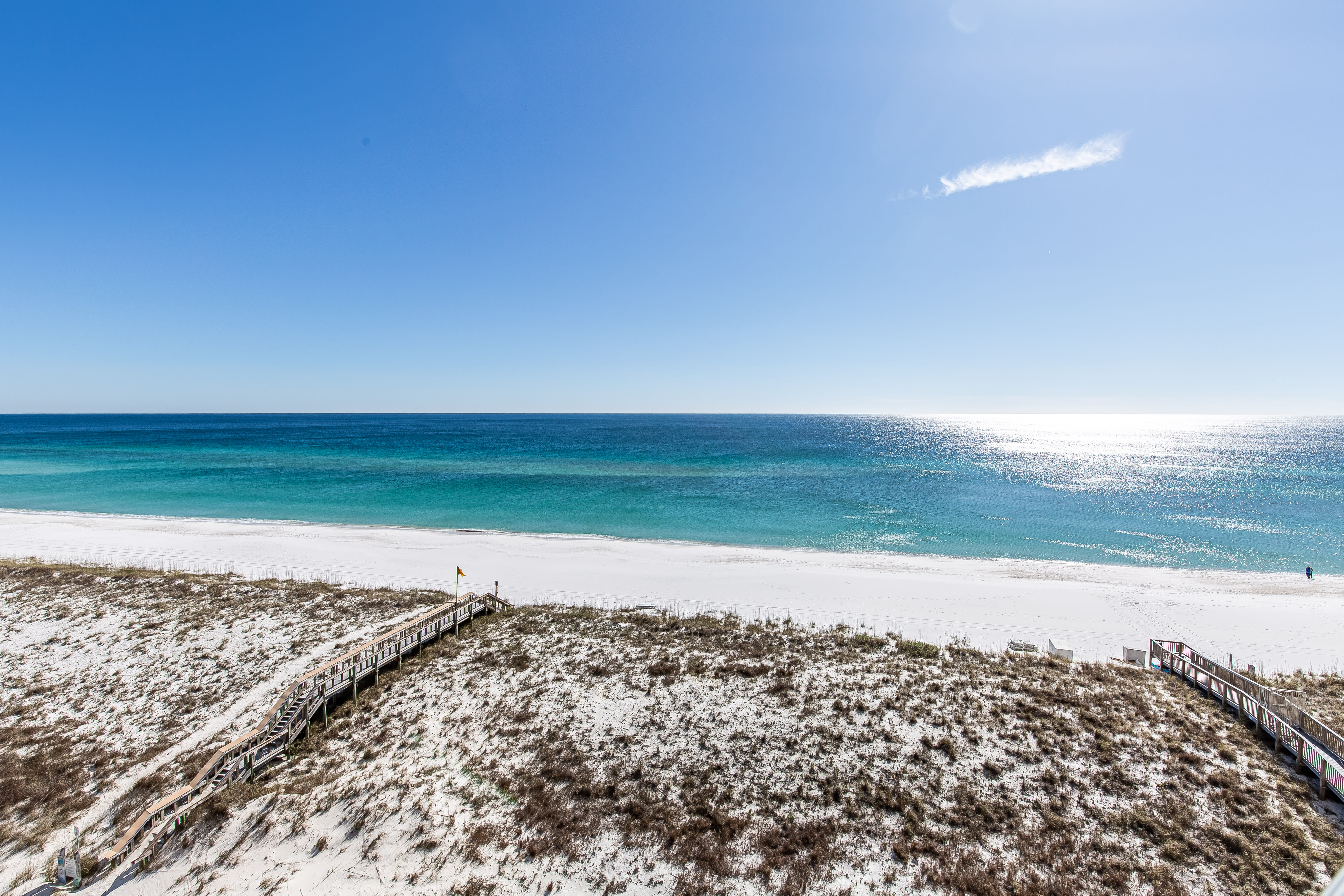 Beach with white sand and emerald waters.