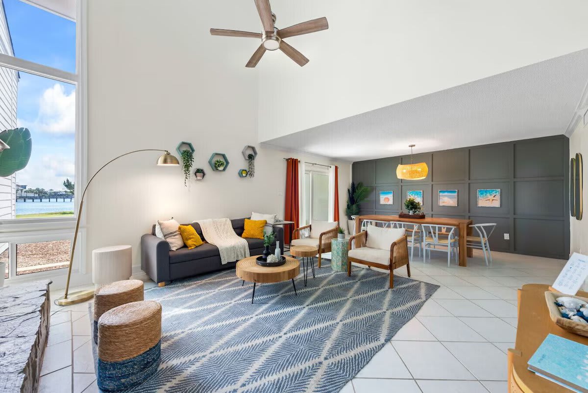 Cozy up at Seabreeze Villa ðŸ”¥ This inviting living room features a warm fireplace and coastal-inspired decor&mdash;perfect for relaxing after a day at the beach. Your seaside escape is just a booking away! ðŸŒ´âœ¨