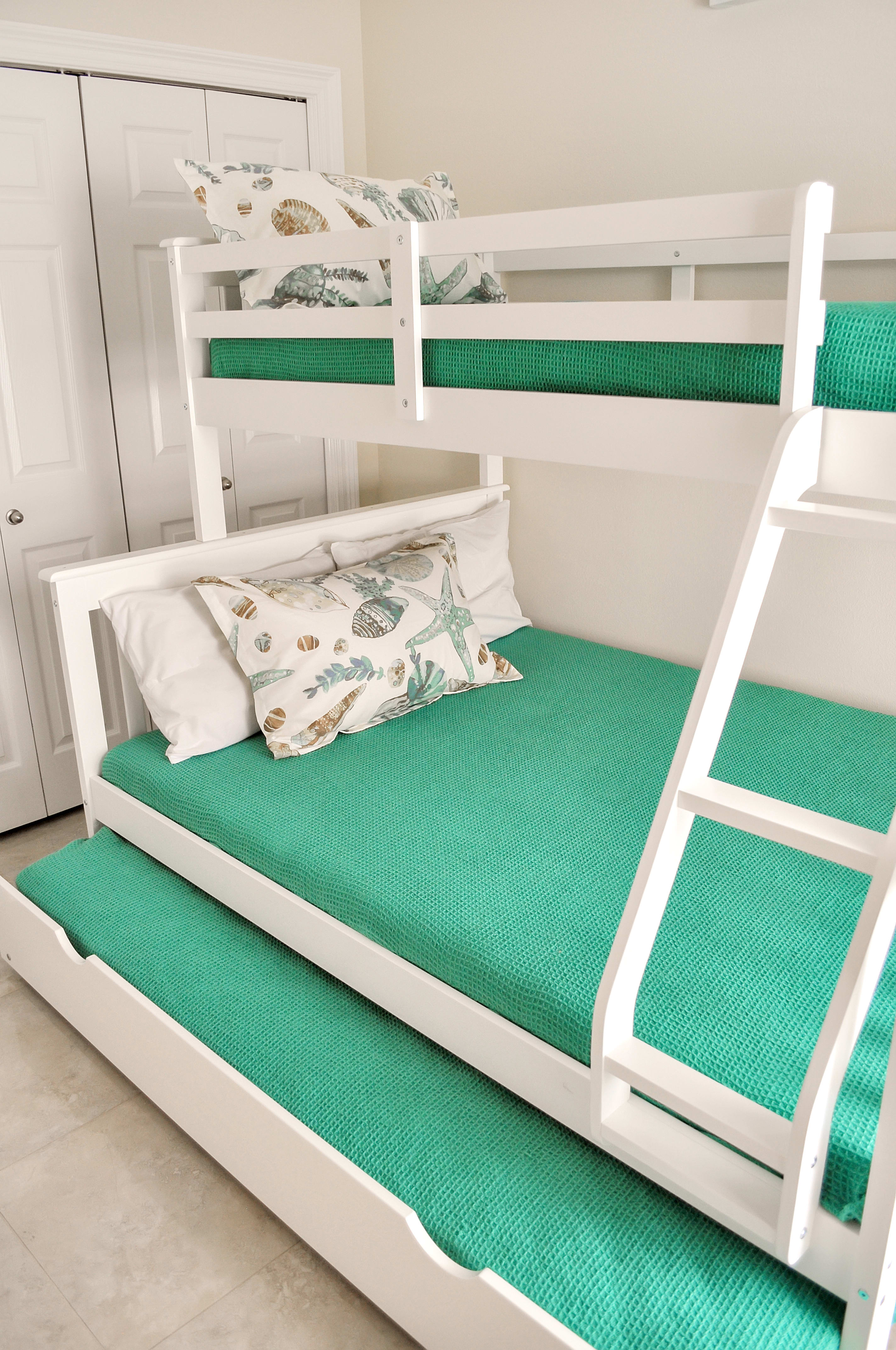 Bunk room with twin over full bunk beds with twin trundle