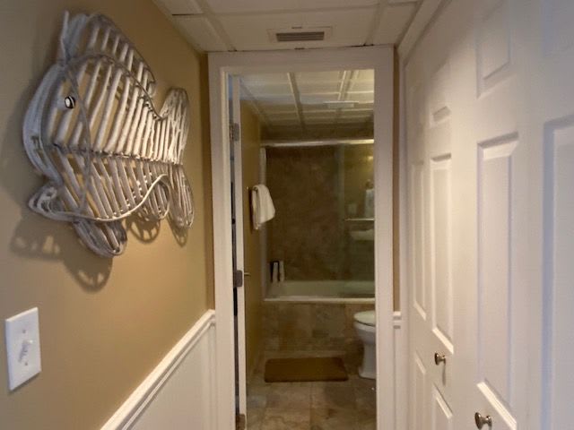 Bath hallway has full size washer and dryer in closet.