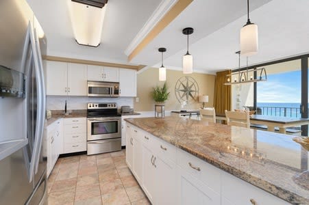Kitchen with raised ceiling and granite countertops