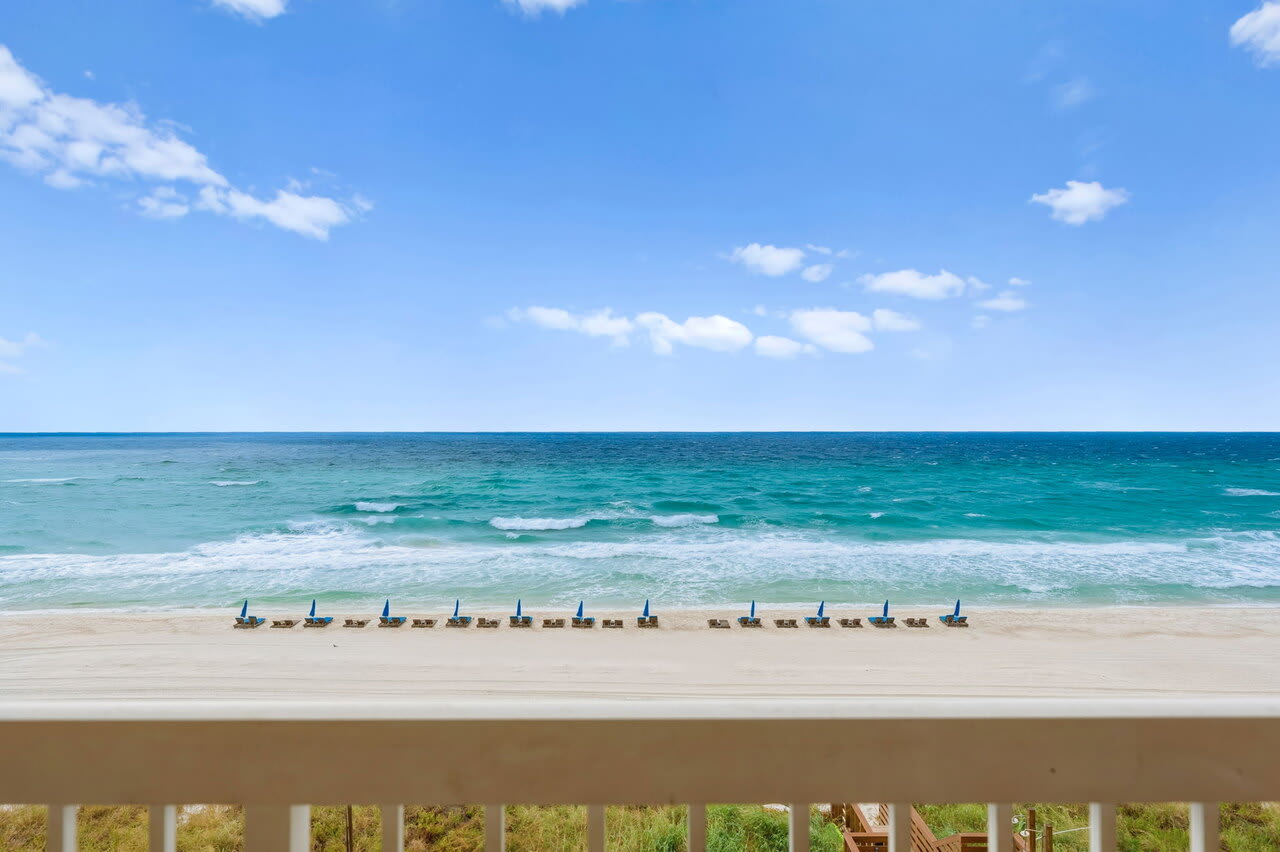 Panoramic Gulf view with turquoise waters, sandy beach, and beach chair setup