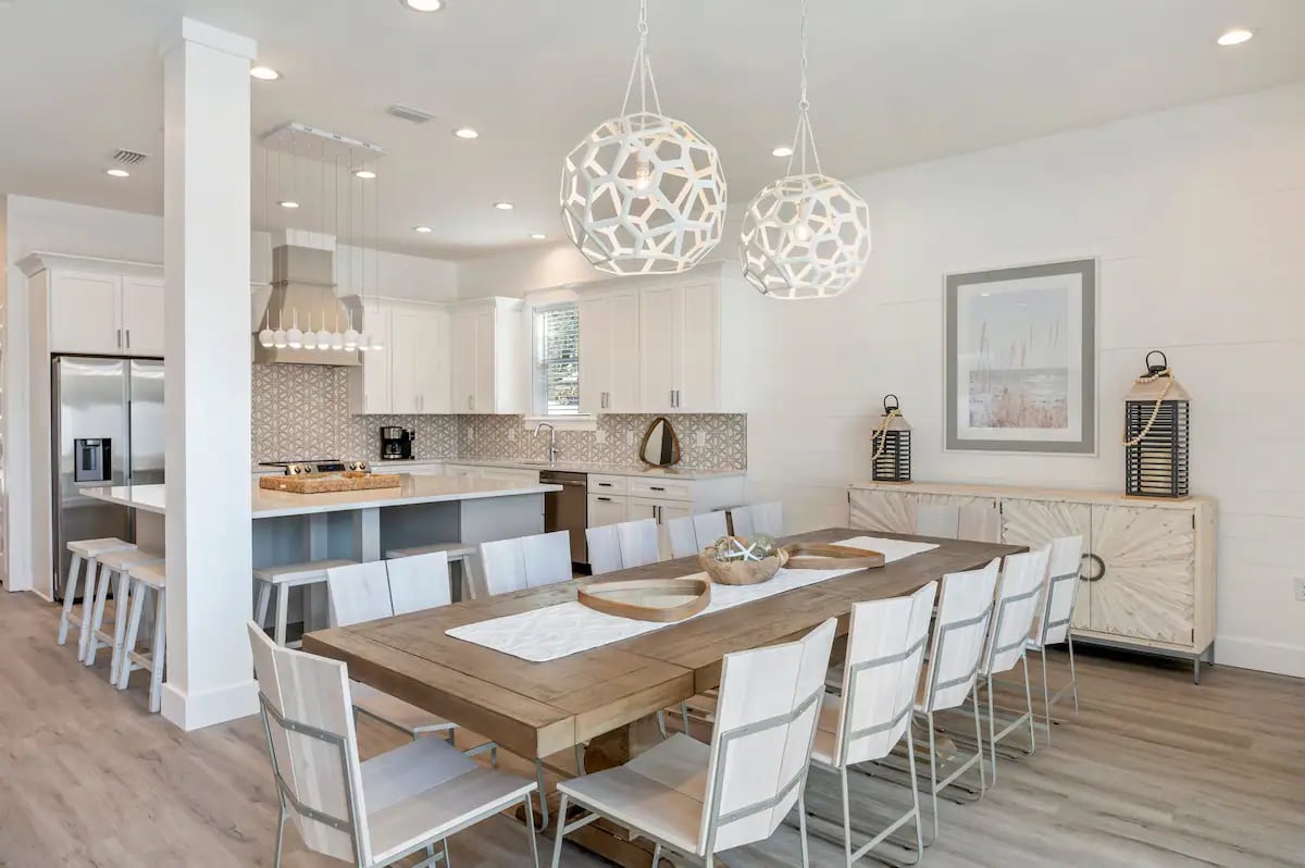 Ovation-11 Plenty of space and dining options for your big group at Ovation. The stylish dining area accommodates 12, with additional seating for 5 at the kitchen island plus outdoor dining area for 4 on the covered patio.