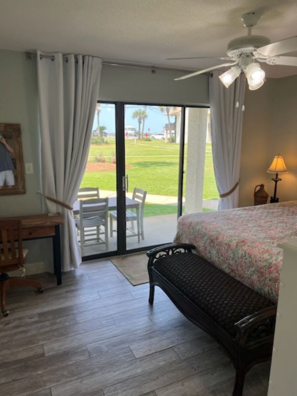 Downstairs bedroom opens up to patio with table and chairs for al fresco dining