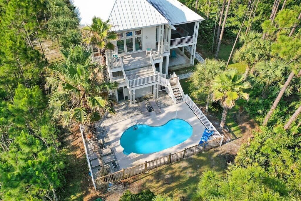 Bayside view of the main house, pool, heated outdoor shower. Pool has gorgeous views of the bay.