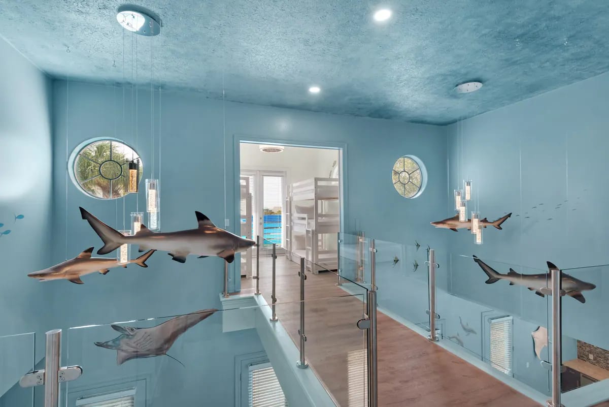 Aqua-15 Glass balcony rails create an underwater feel as you pass circling sharks.
