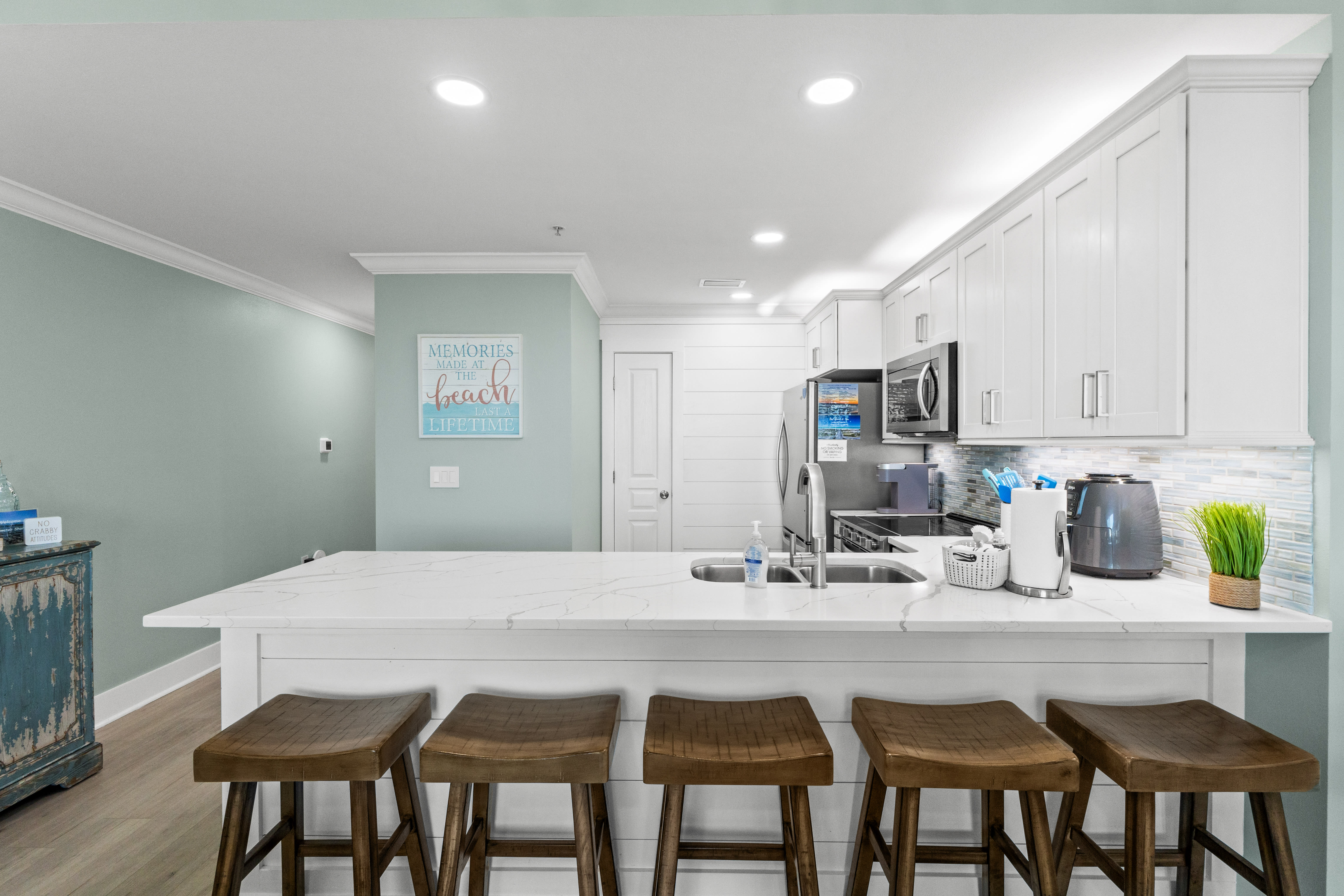 All-new coastal kitchen with sleek quartz island that seats 5 