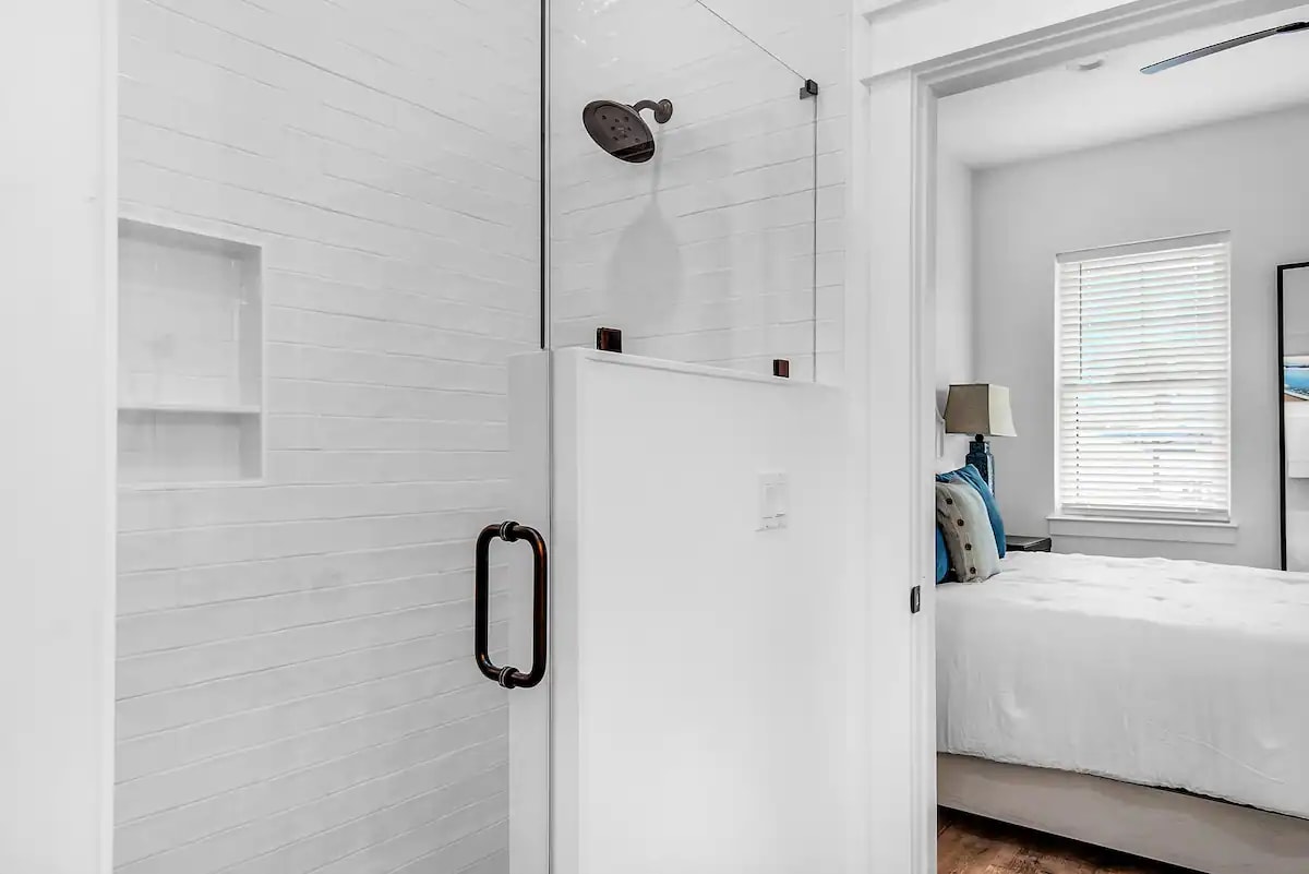 Latitude-21 1st floor. Bed 2 bath, photo 2. Quartz vanity with tiled, frameless glass walk in shower.