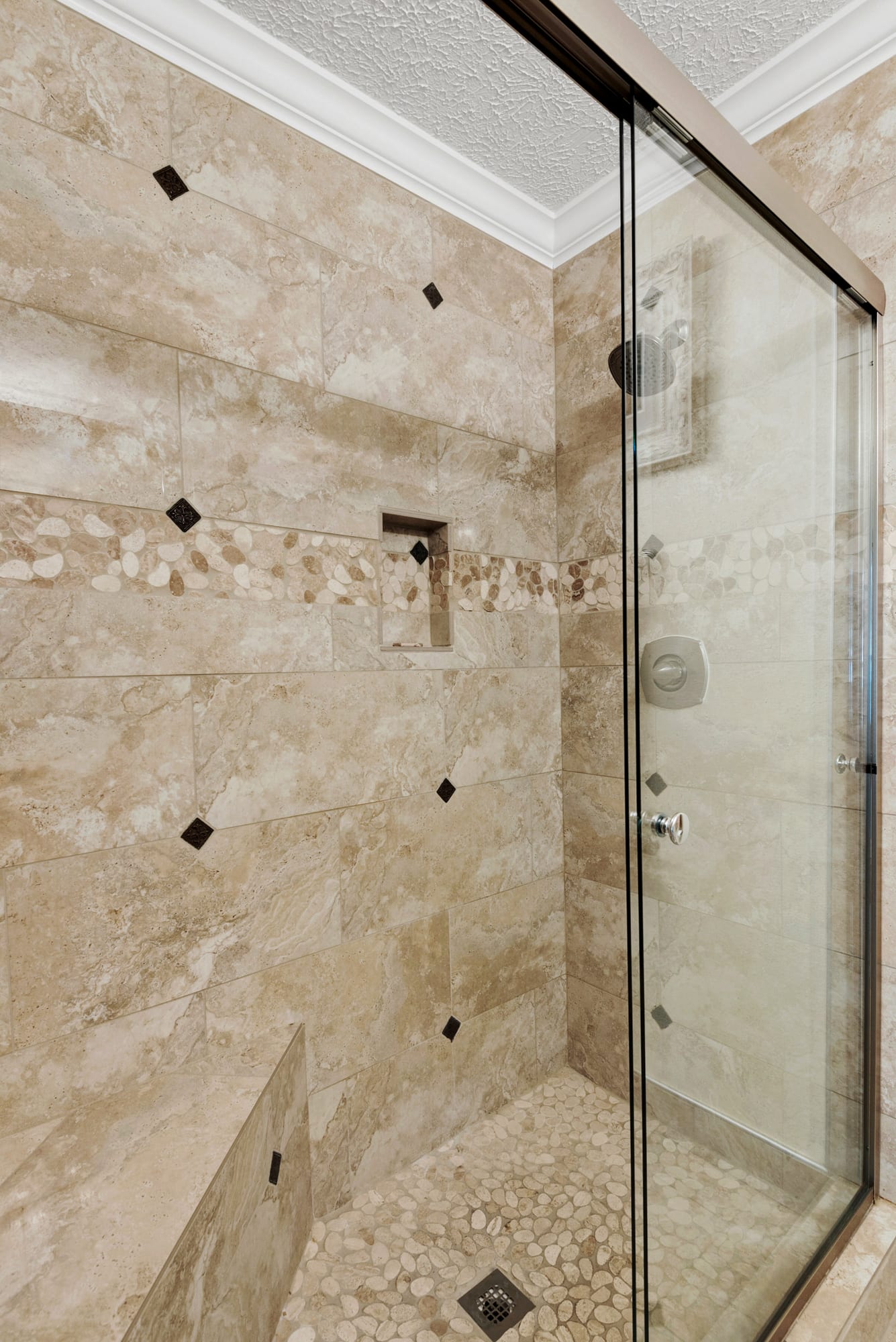 Walk-in shower adjacent with 2nd bedroom with porcelain tile and river rock