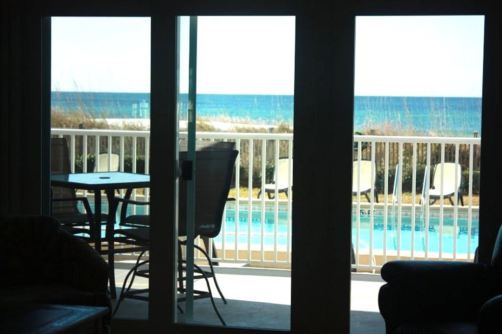 View from inside the condo to pool and beach