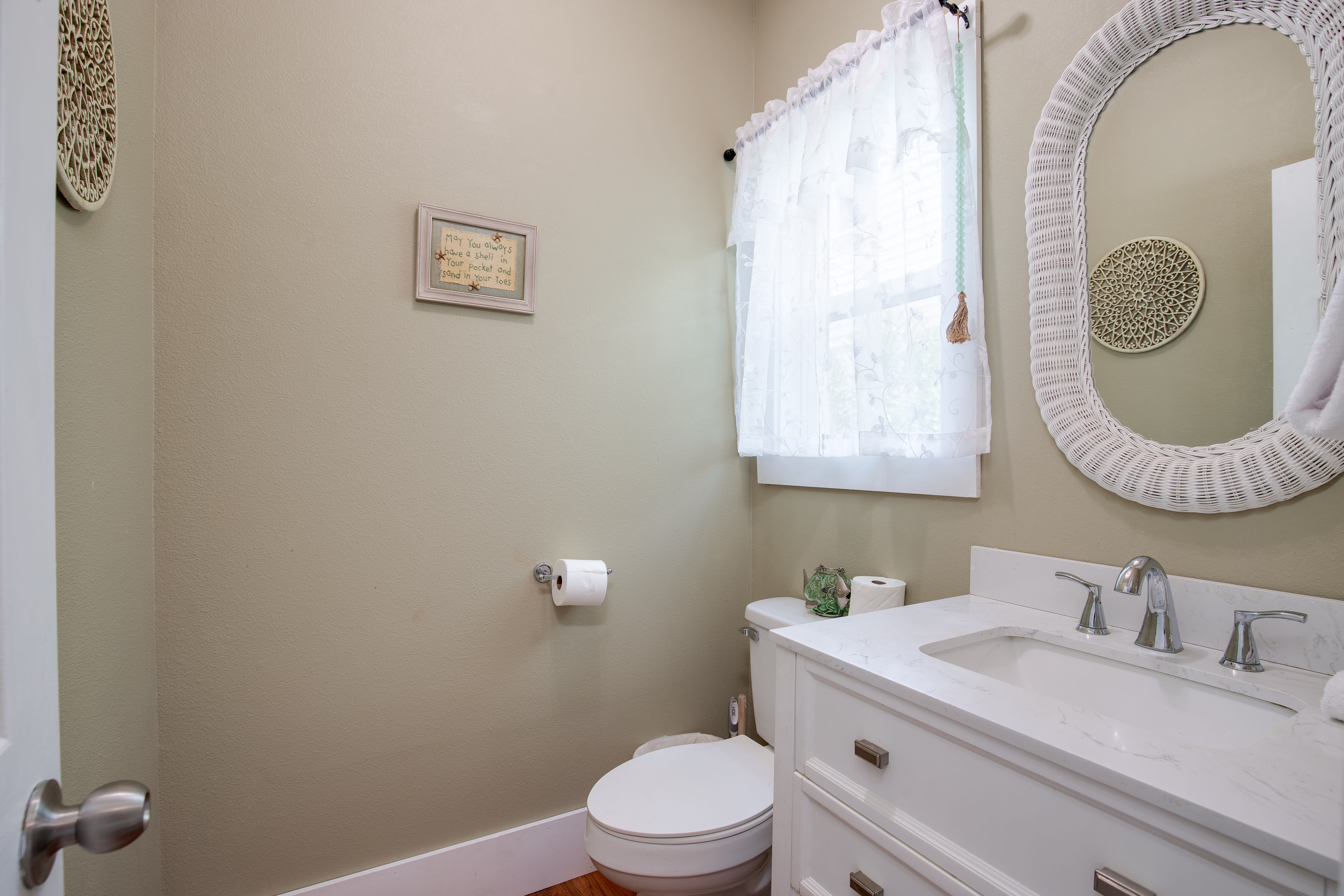 Half bath conveniently located just off the kitchen.