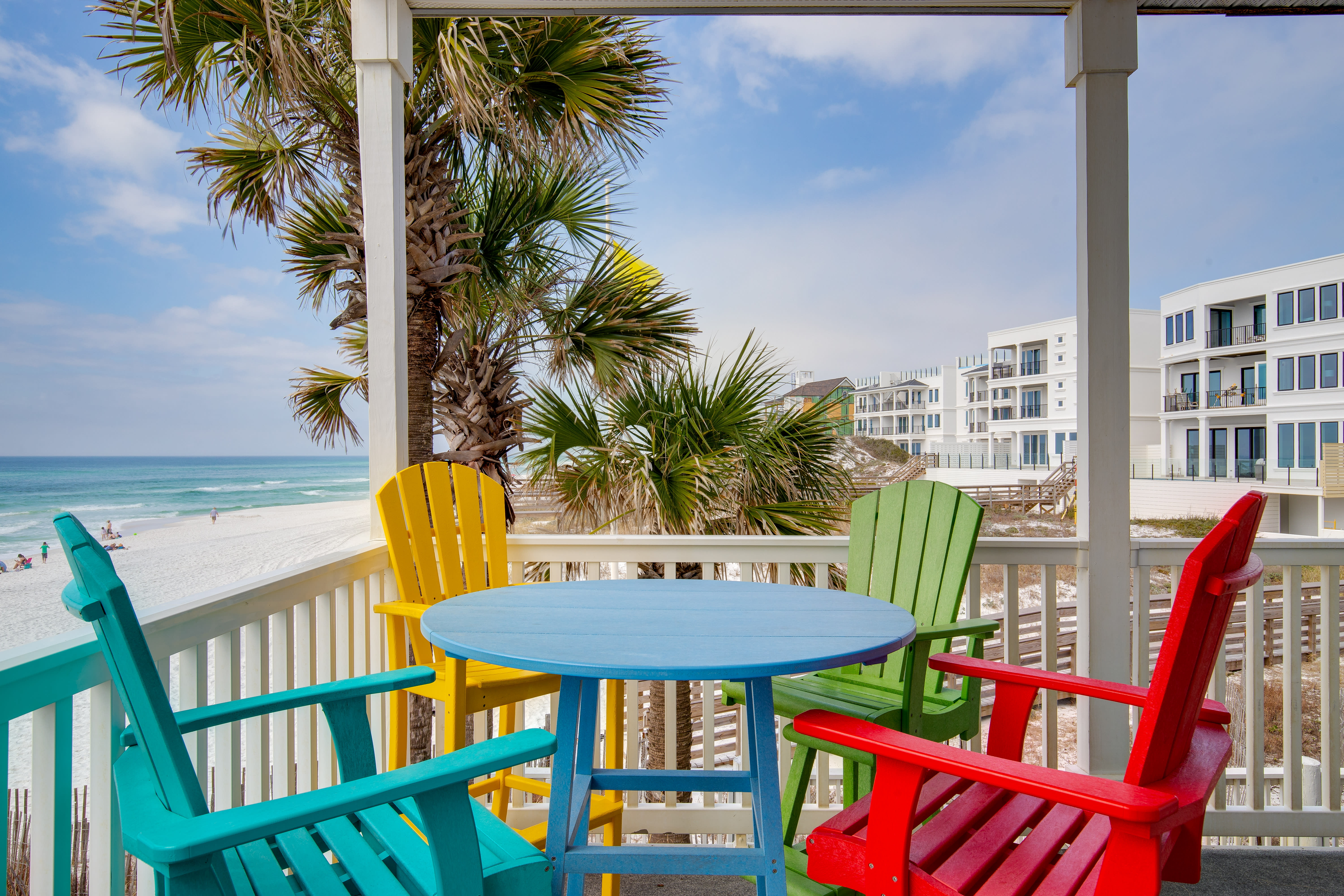 Wraparound deck with high top table and chairs for outdoor dining
