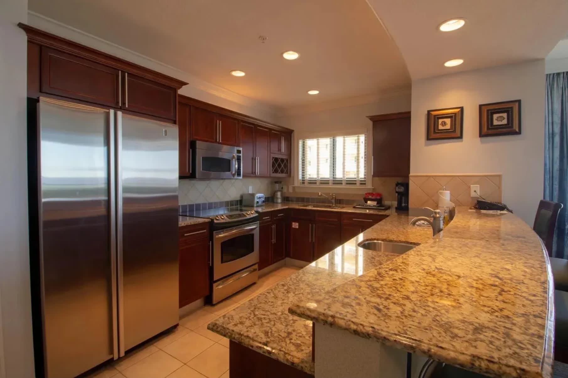Large kitchen with all the appliances, and breakfast counter seating.