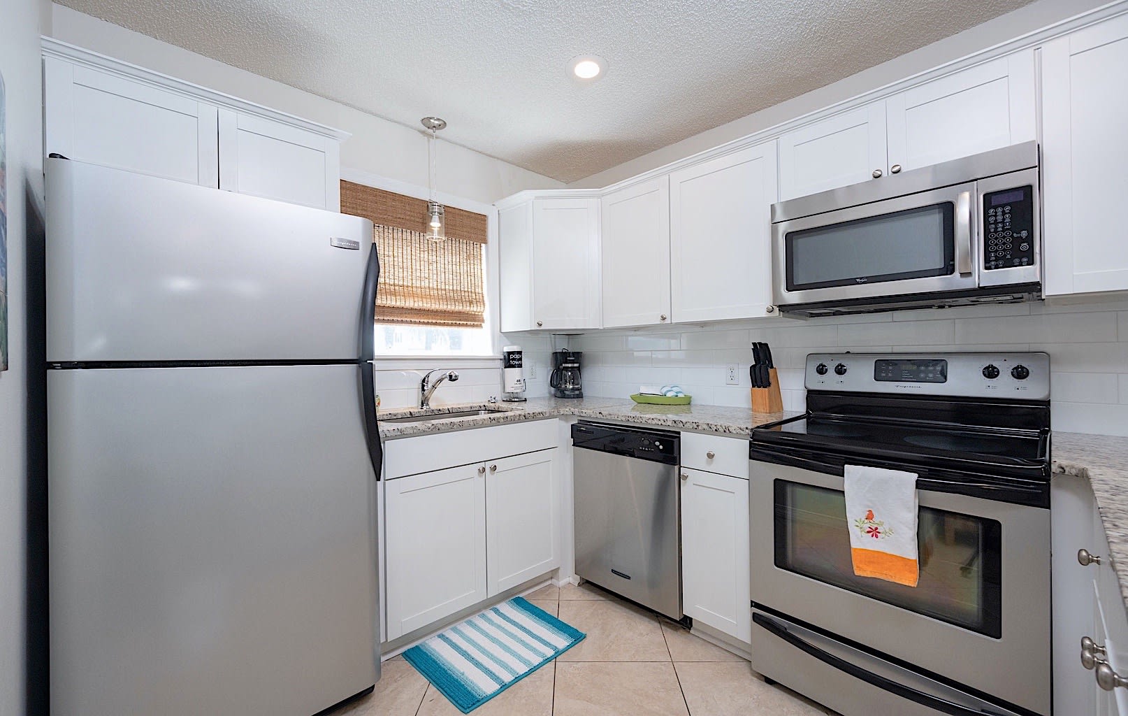Open, well stocked kitchen with granite countertops, dishwasher