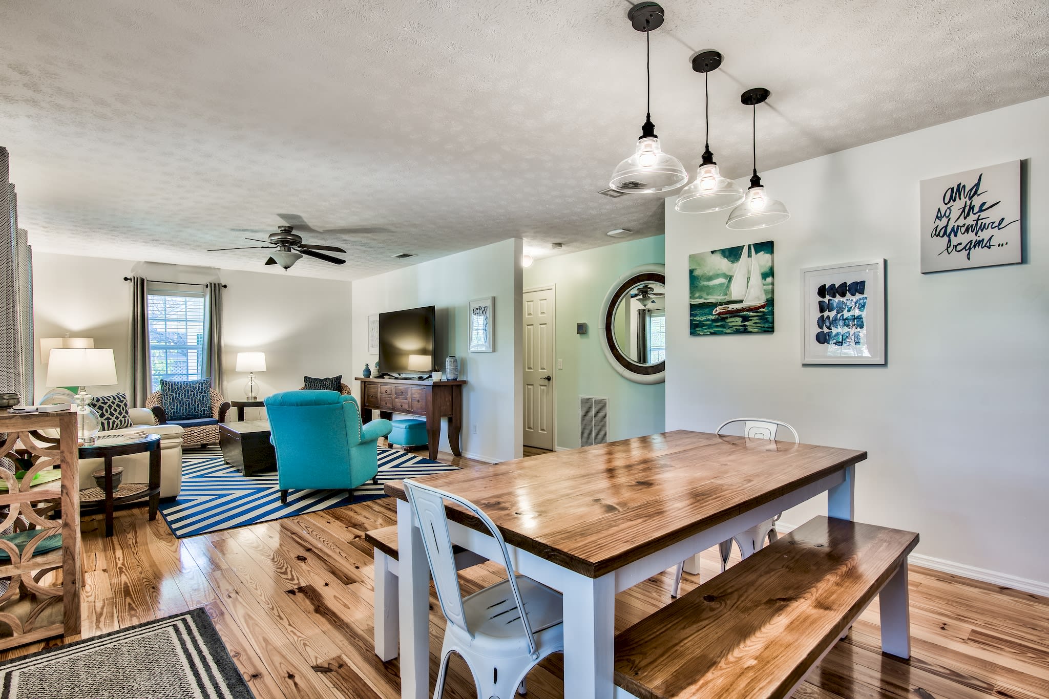 Open concept living and dining, complete with a large, farmhouse-style table.