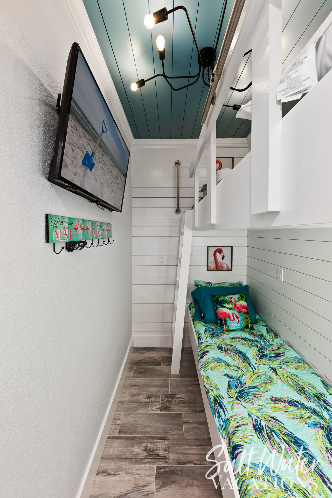 Bunk nook room featuring single over single bunks &amp; 50&rdquo; tv