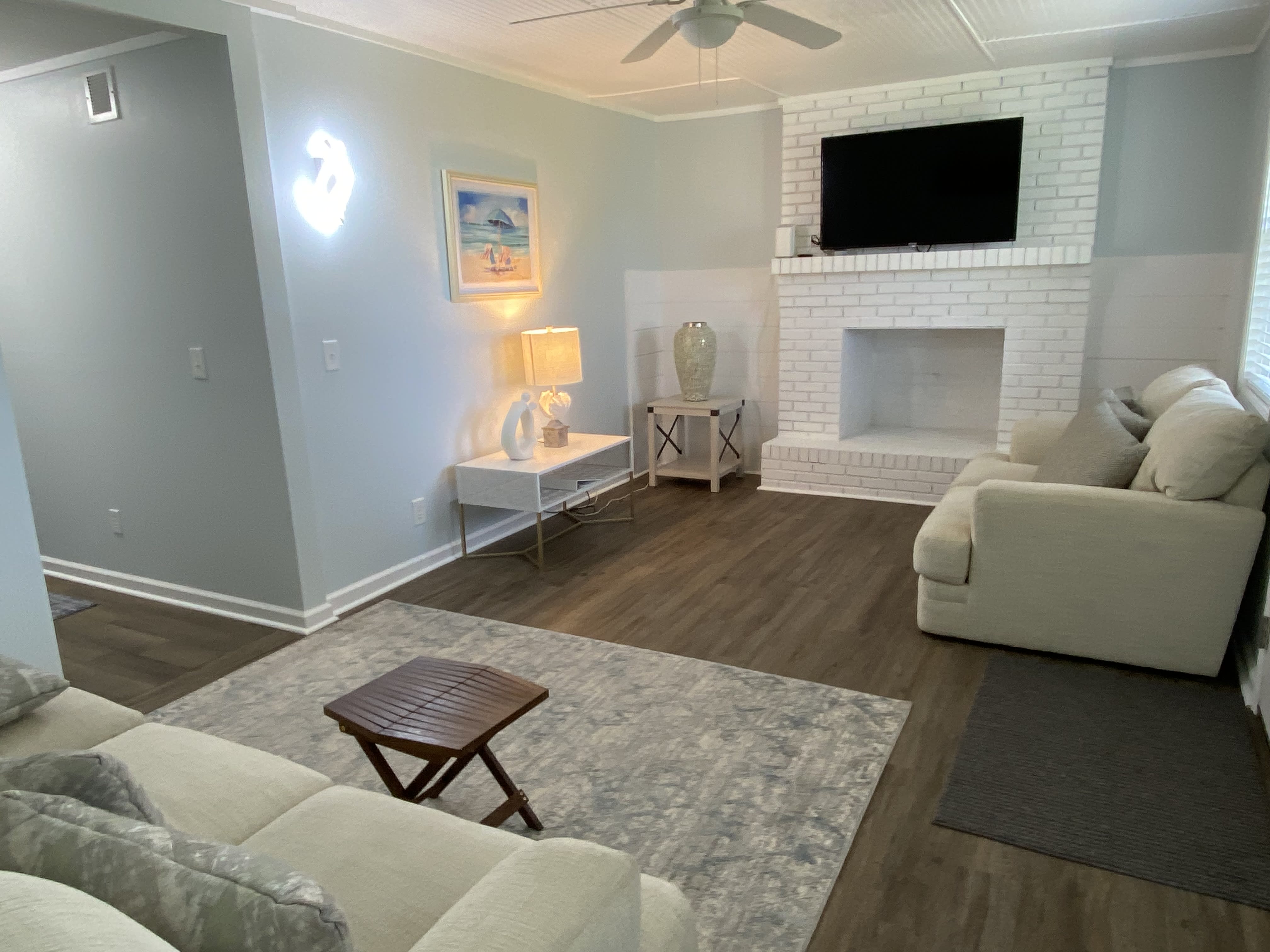 Living room with sofa, loveseat and big screen TV 
