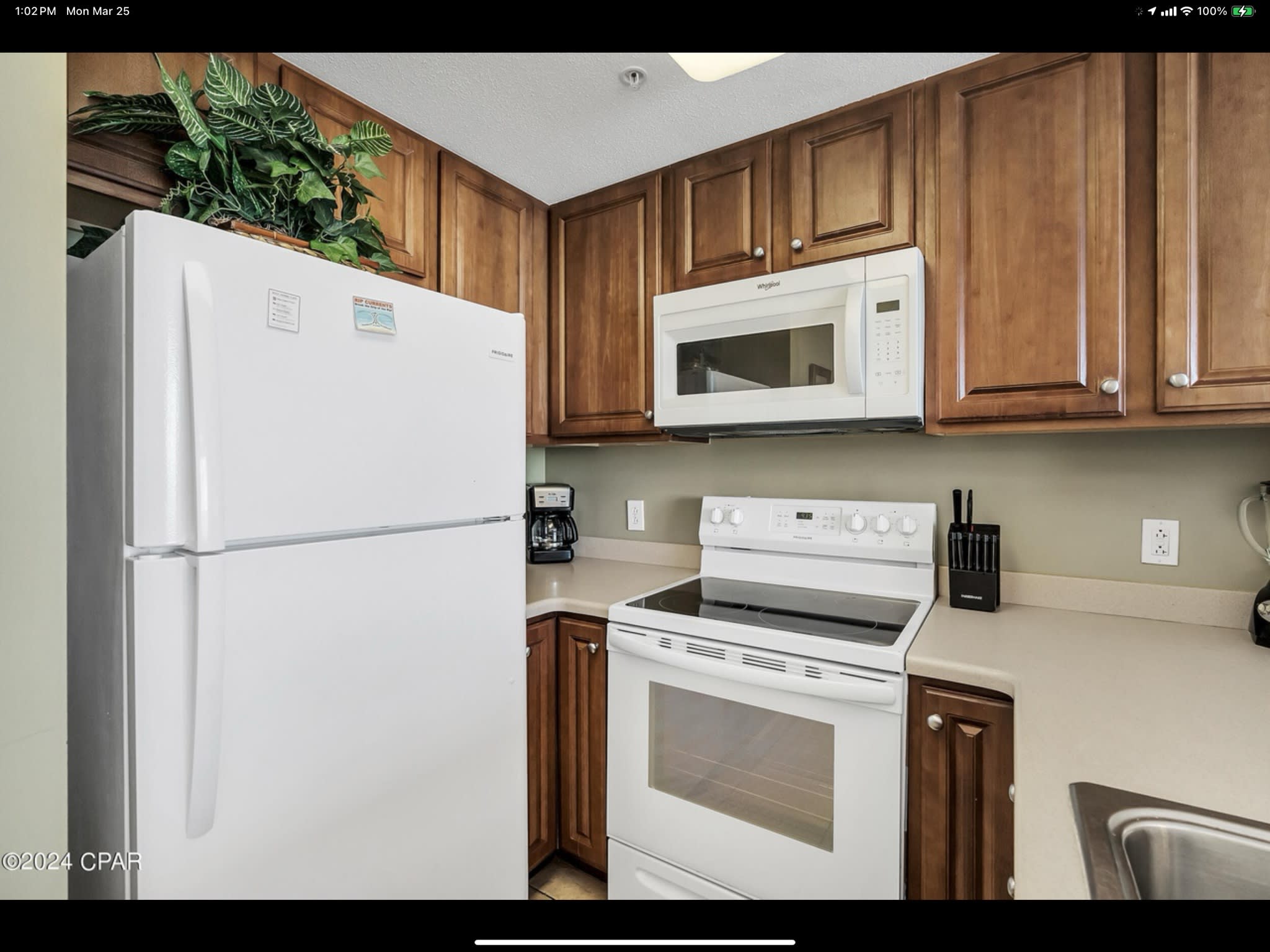 Fully equipped coastal kitchen with breakfast bar and open living space