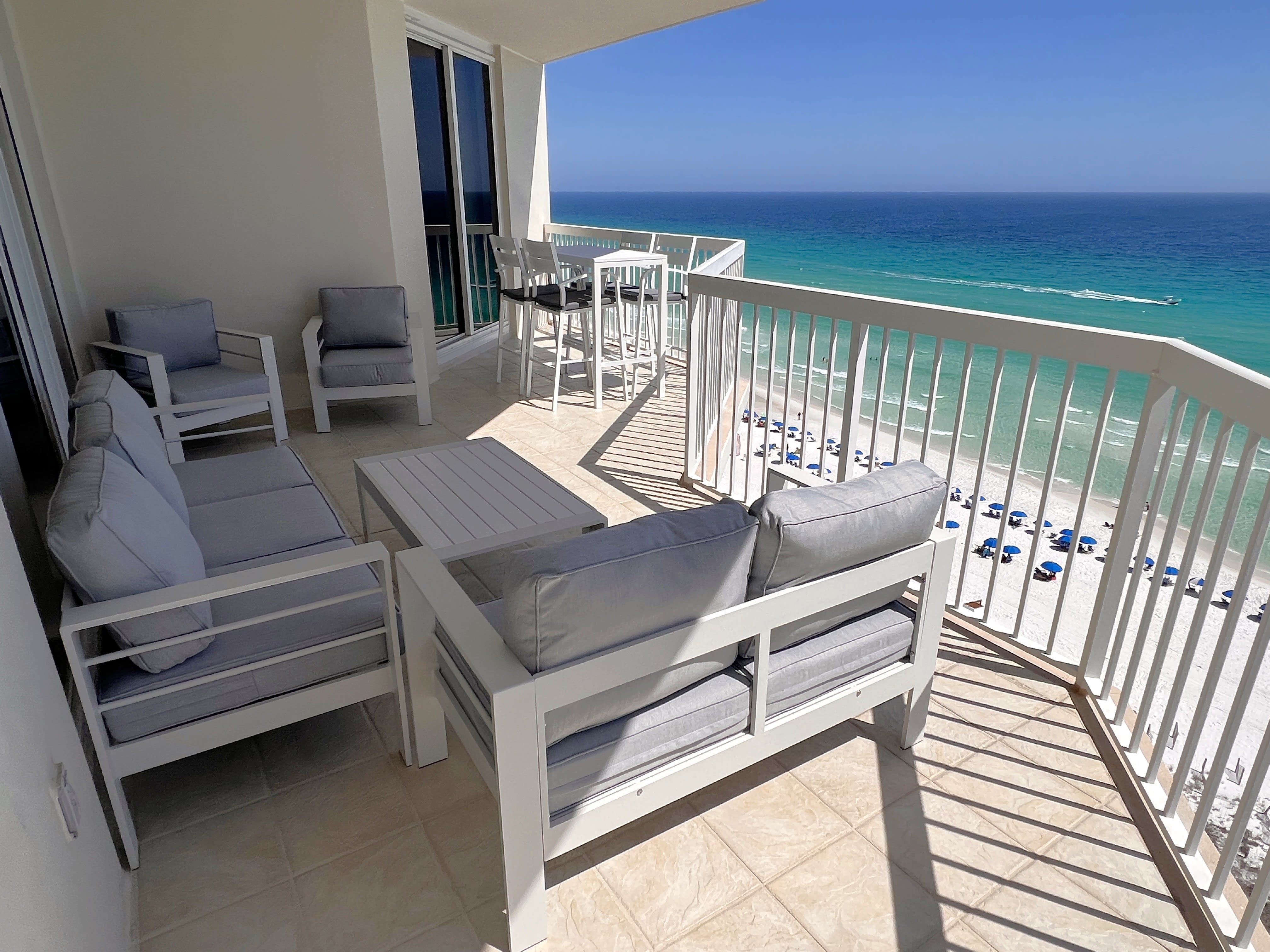 Large ocean front balcony with outdoor sofa, loveseat and 2 chairs seats seven!