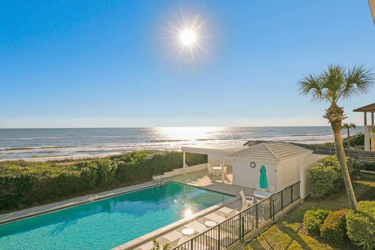 View from balcony looking West of pool, dunes, beach and gulf