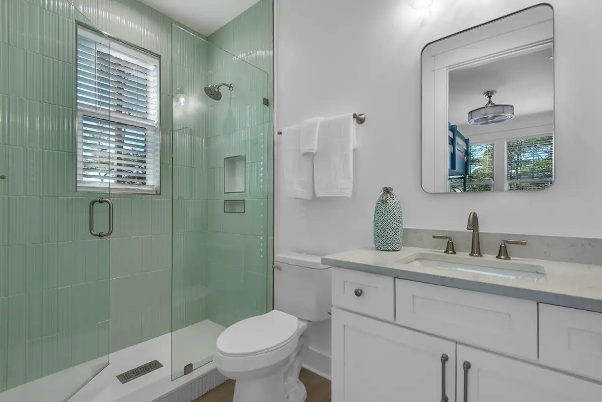 Whimsy-23 Bedroom 3 Bath. Pic 1. Bunkroom with attached bath with quartz vanity and frameless glass shower
